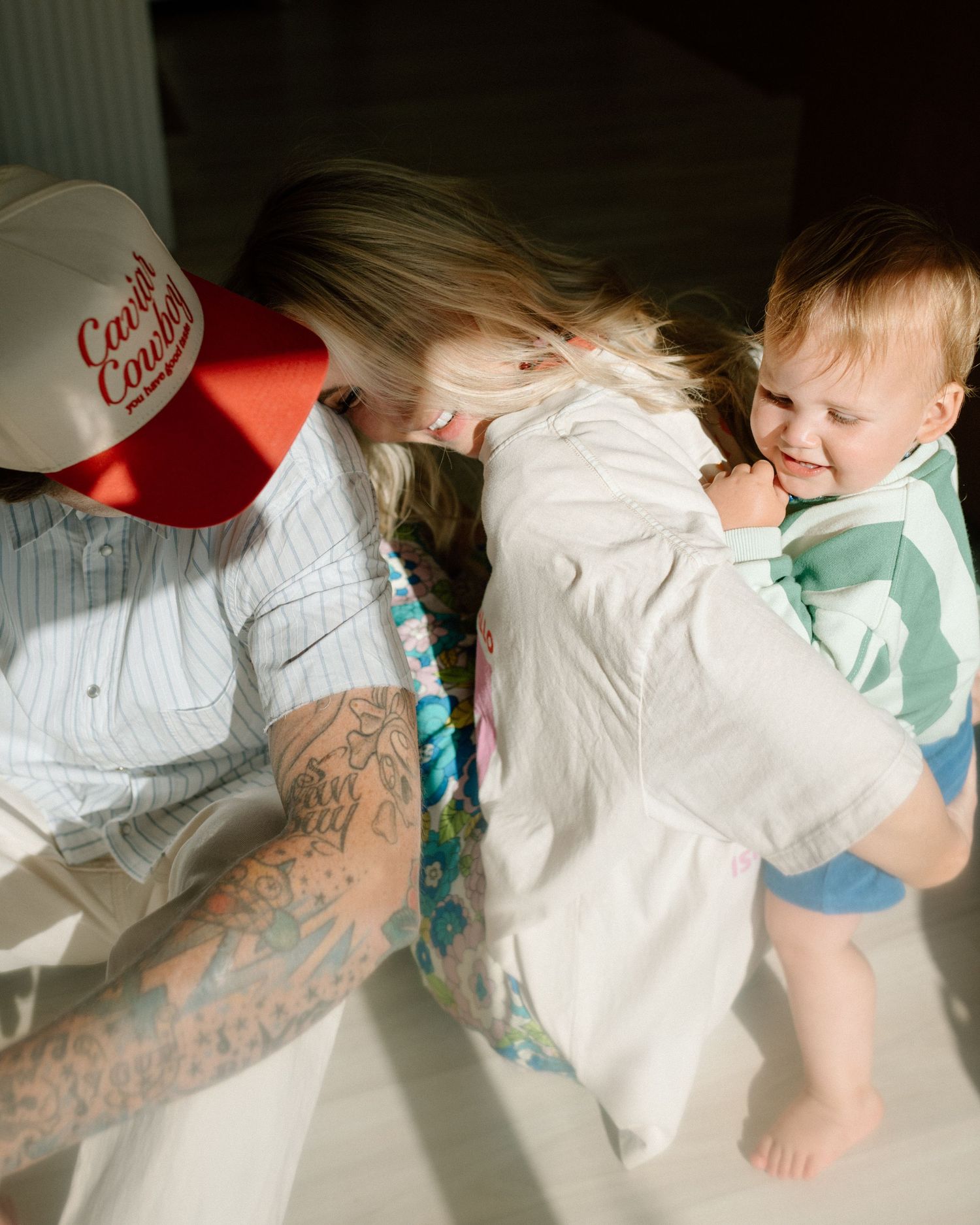 Fun candid lifestyle moment of interactions between people wearing casual attire in natural indoor lighting.