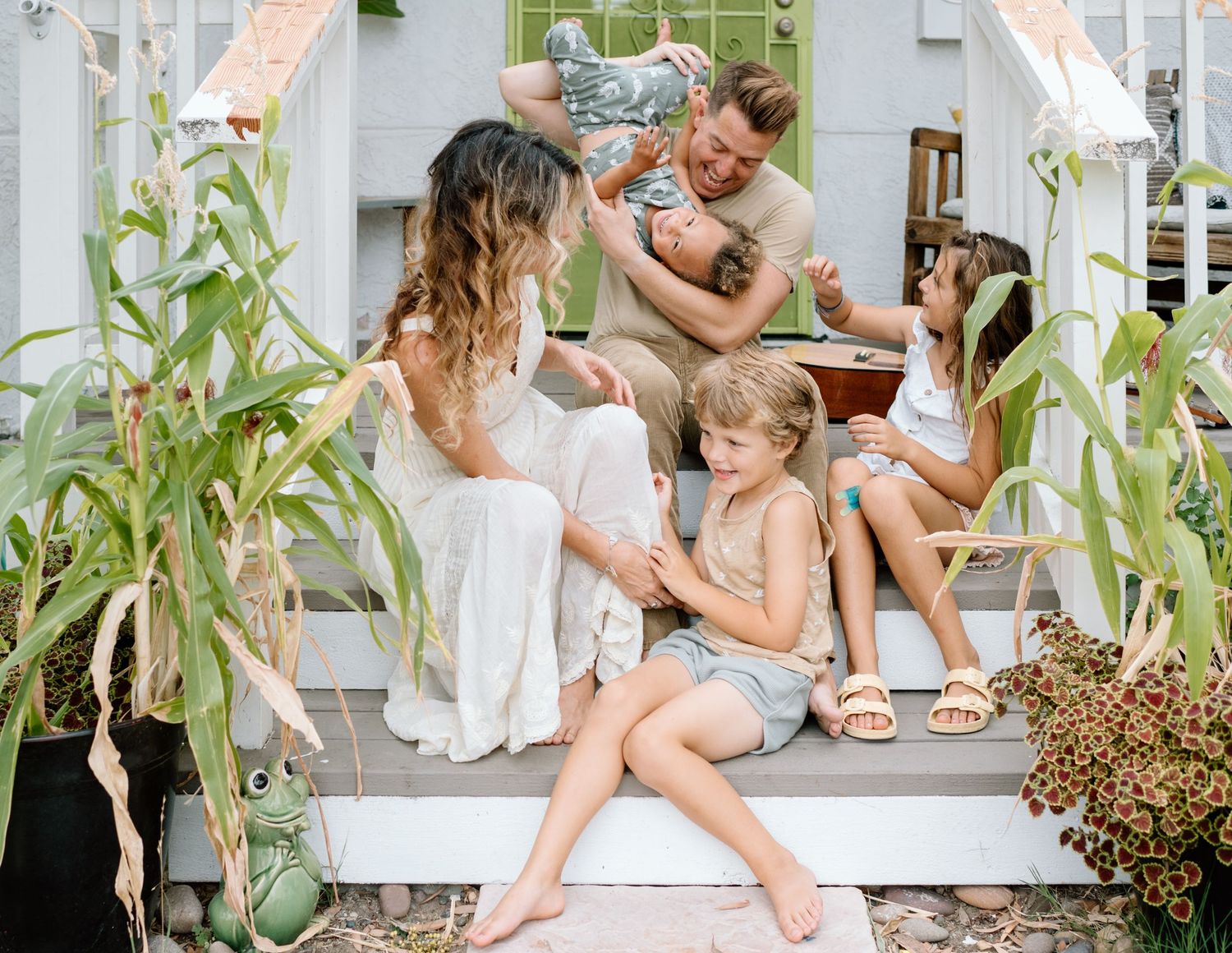Family being silly on porch during at home family photoshoot in San Diego