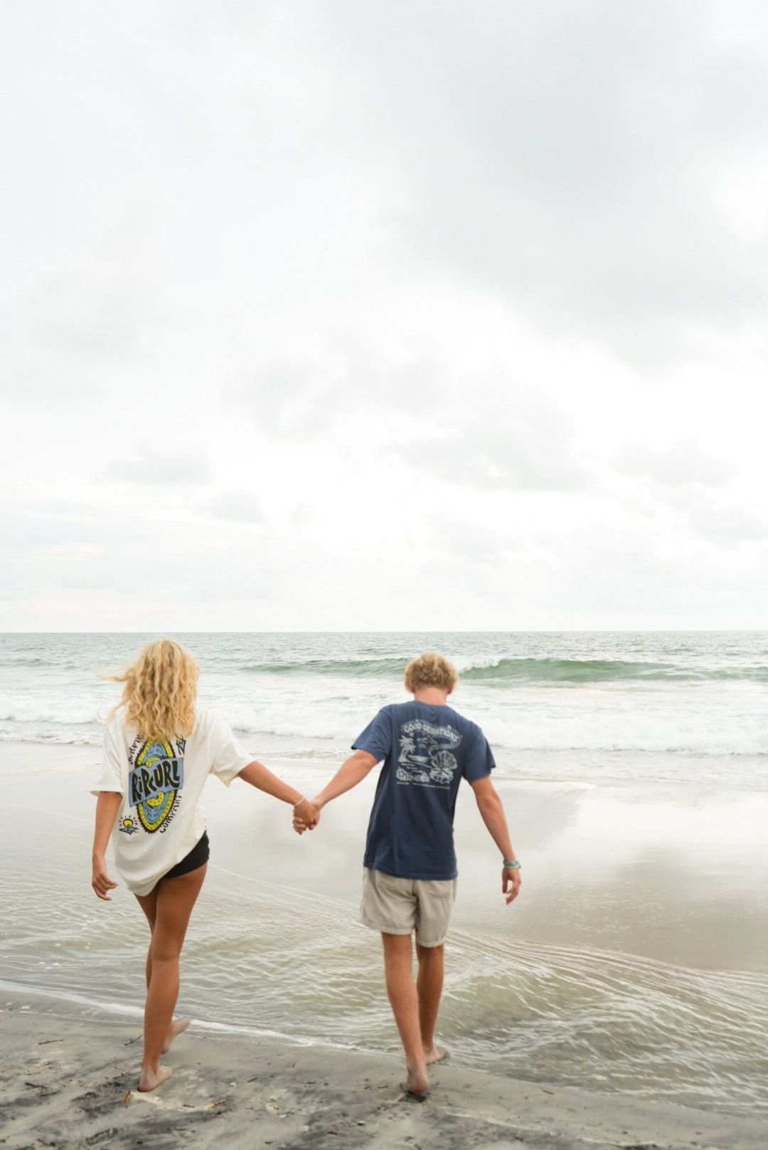 Picture of a couple walking down the beach taken by a photographer in Pawleys Island, South Carolina.