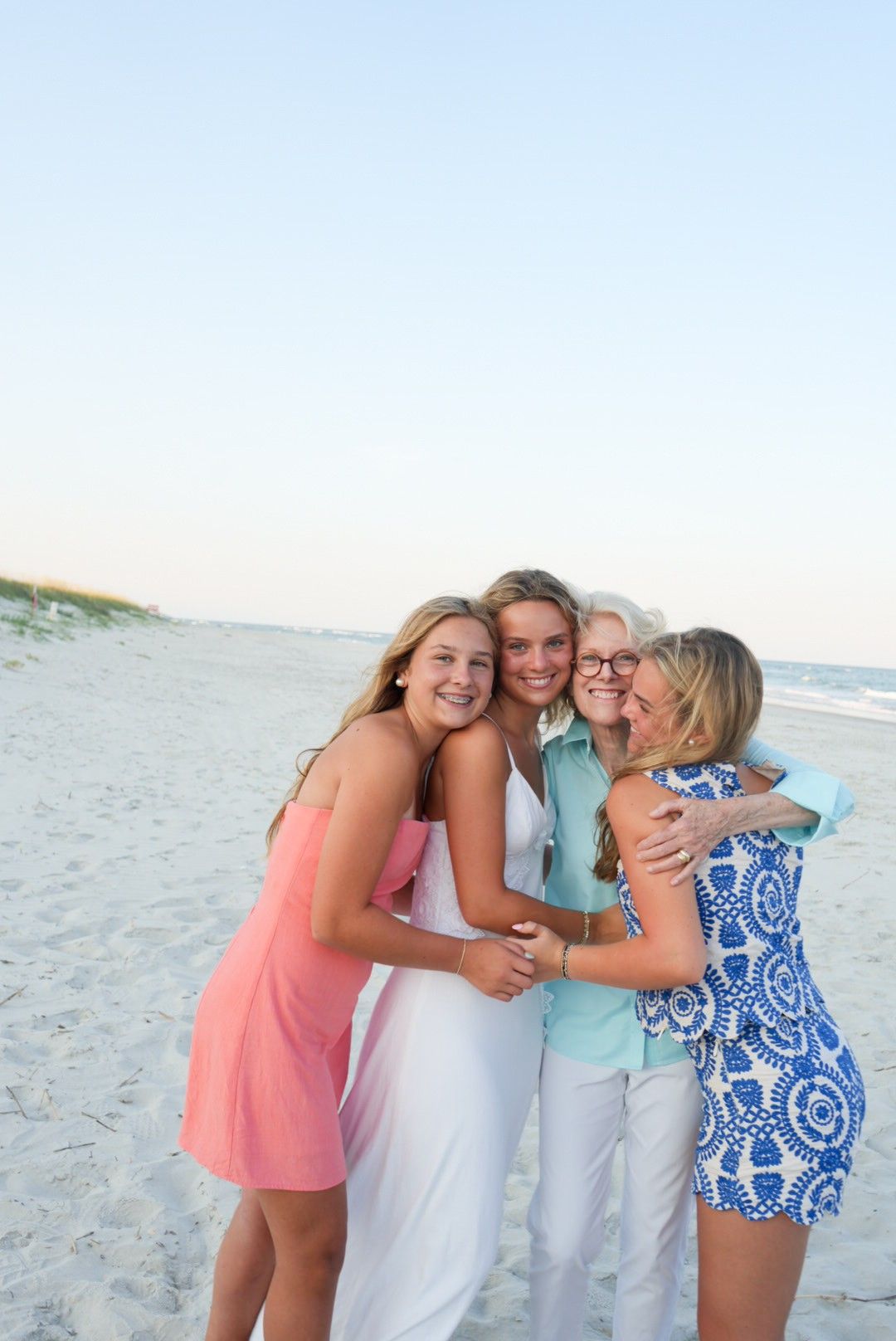 Vacation family smiling and hugging during a family photoshoot in Pawleys Island, South Carolina.