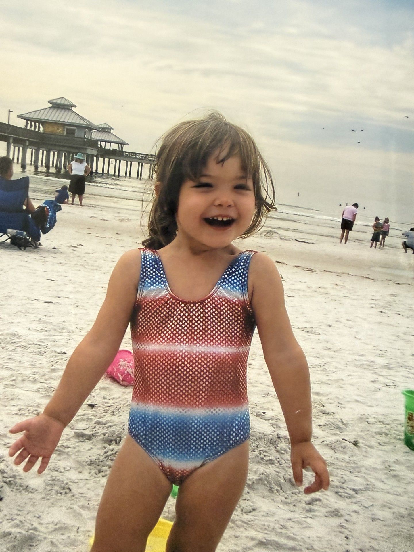 Young girl smiling on the beach.