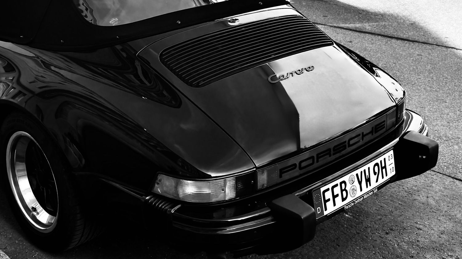 Black and white photo of a classic Porsche 911 Targa rear view with German license plate FFB-VW-9H.