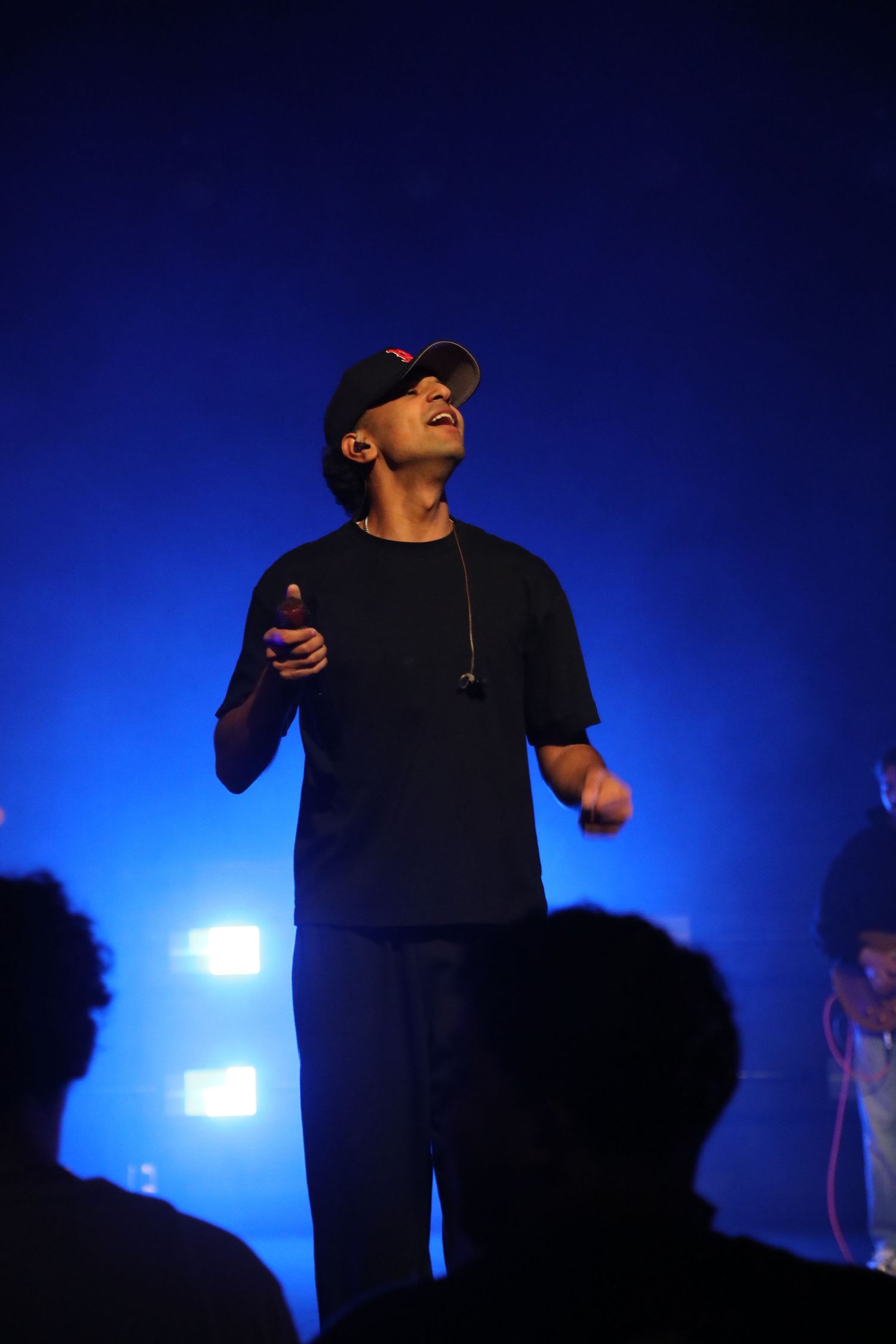 Man singing with blue and black lighting