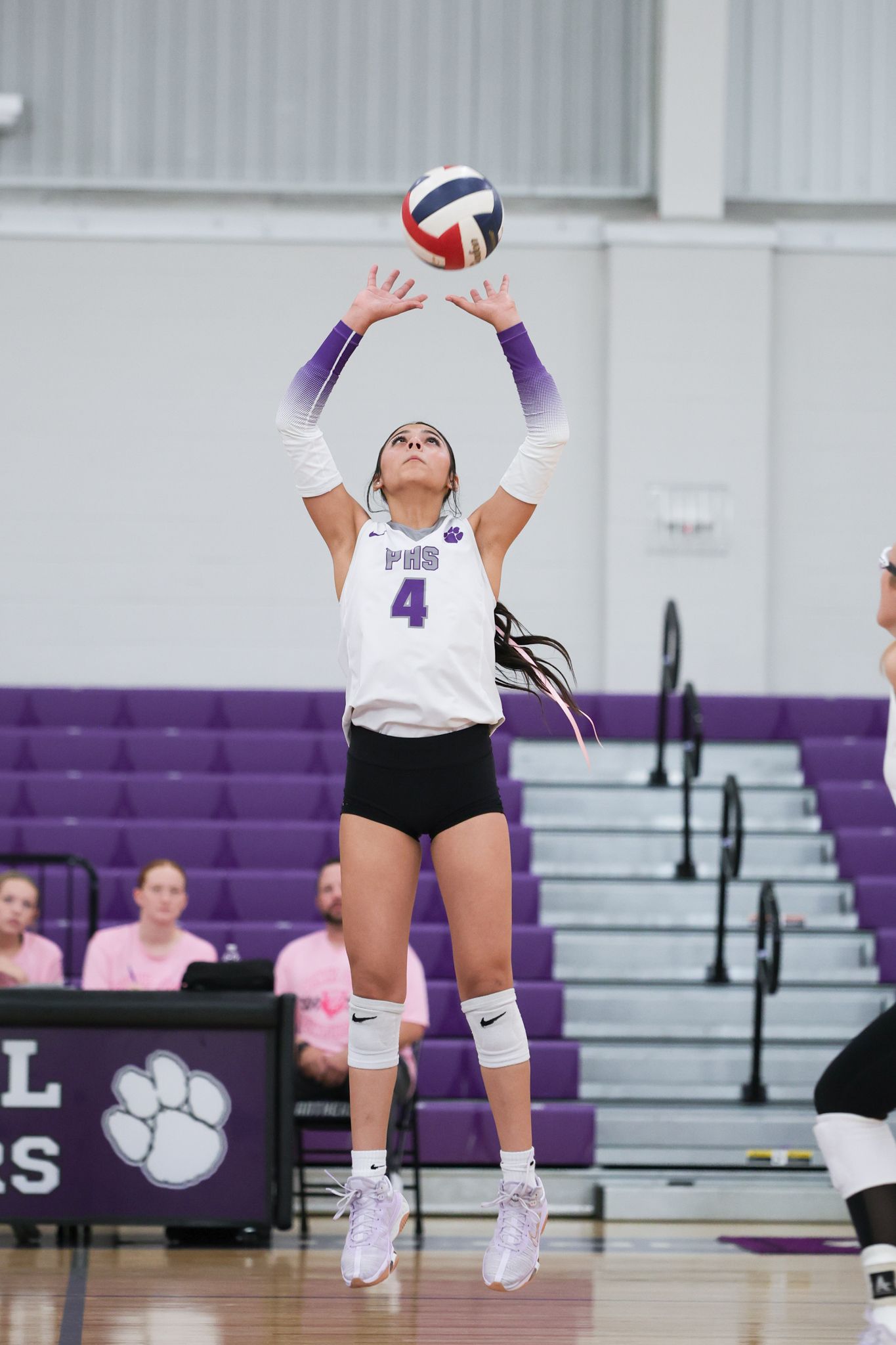 R.L. Paschal High School Volleyball player sets the ball in the air at a rivalry game.