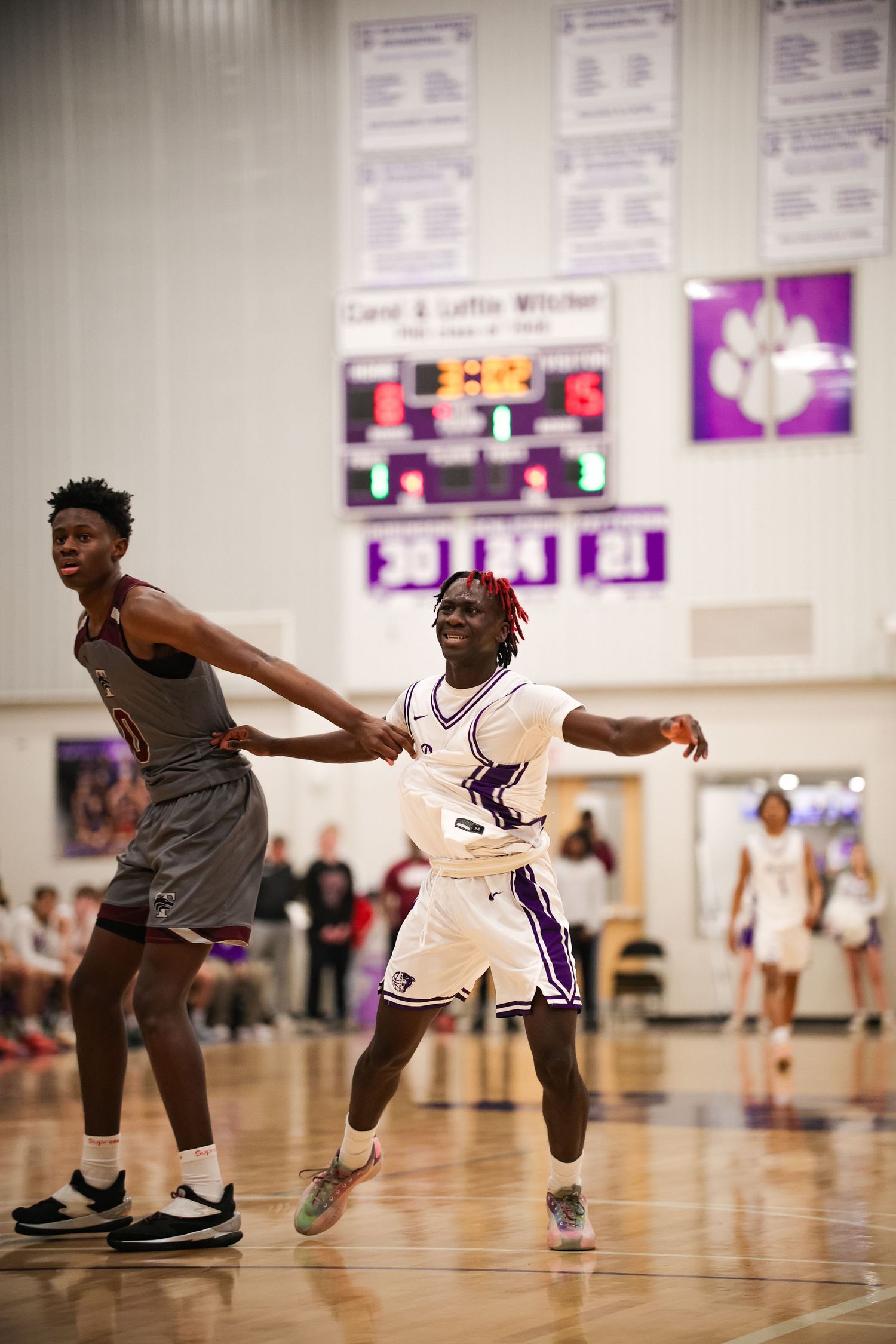 R.L. Paschal High School holds a Varsity Basketball game in The Gus Bates Center where a Panther is jumping around the court to stay open.