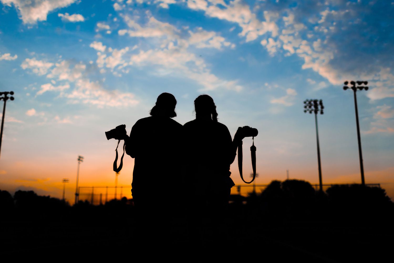 R.L. Paschal High School Yearbook and Media members pose for a silhouette photo displaying the sunrise over the schools senior sunrise.