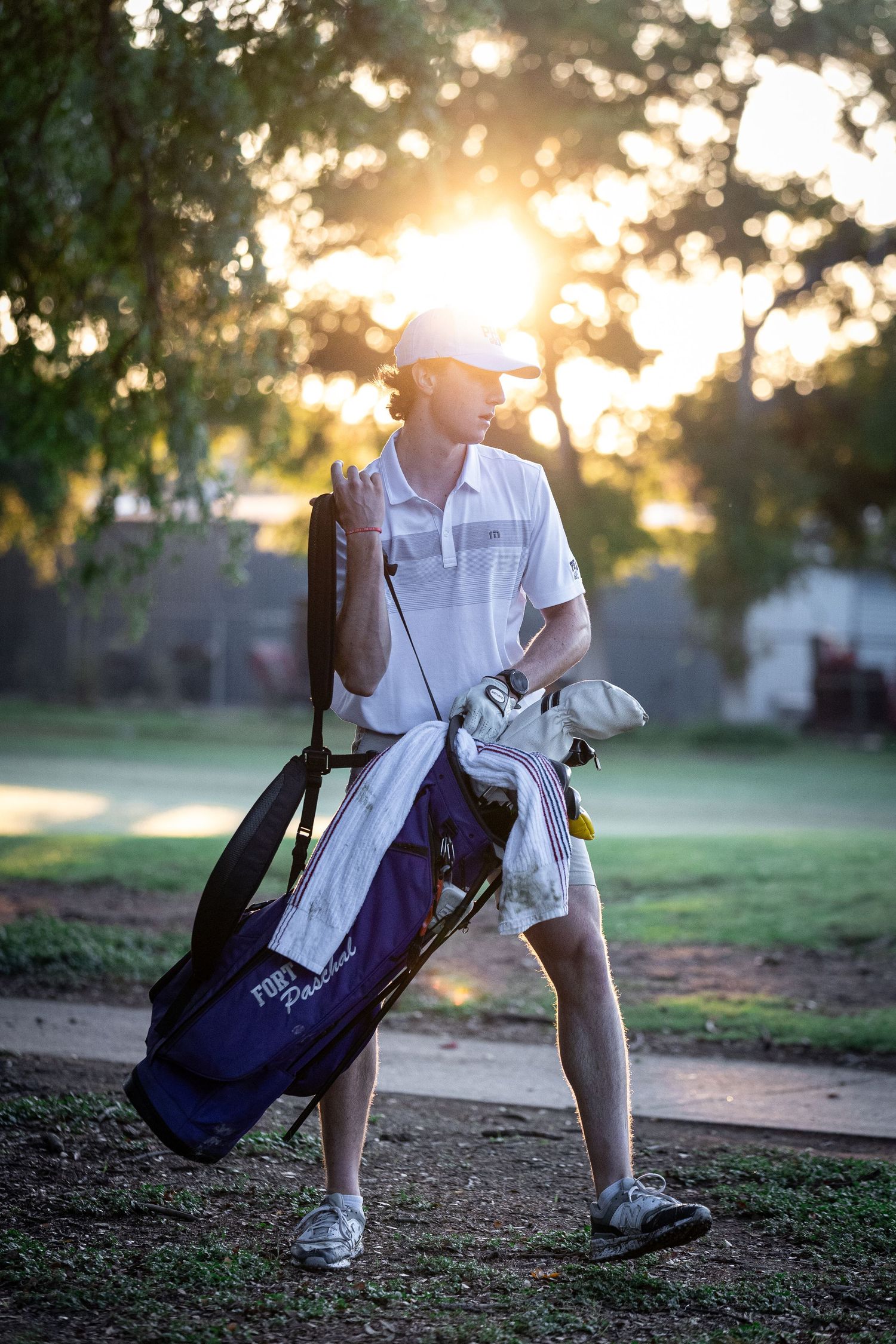 R.L. Paschal High School Varsity Golf player carries his clubs at The Bart Granger Tournament at Pecan Valley in Benbrook, Texas.