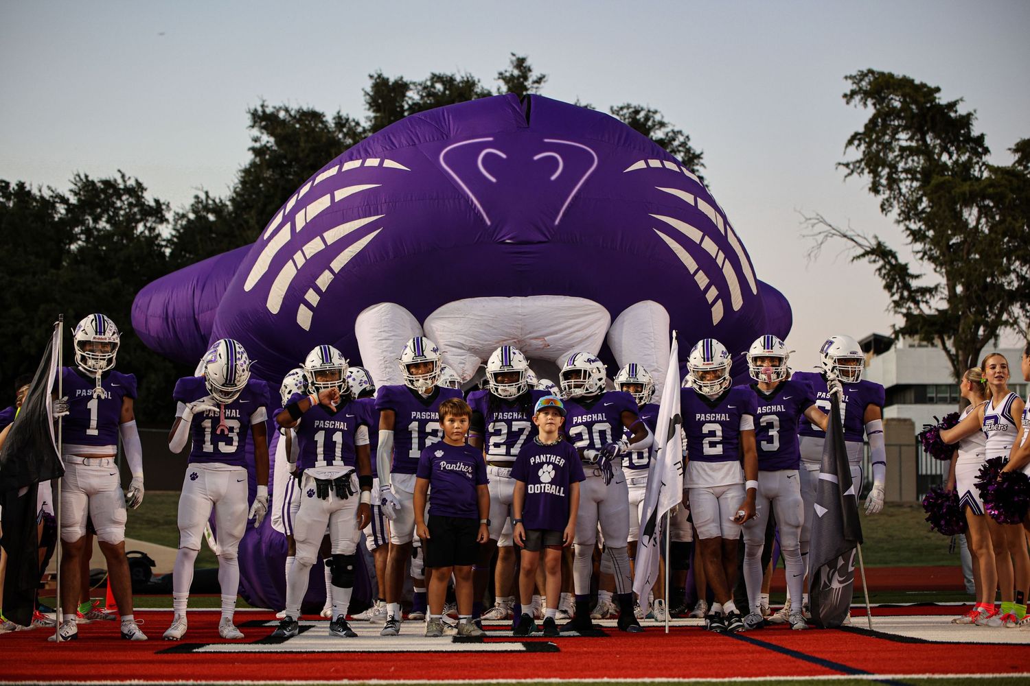 R.L. Paschal High School's Varsity Football team gets ready for a game standing in front of the iconic Panther.