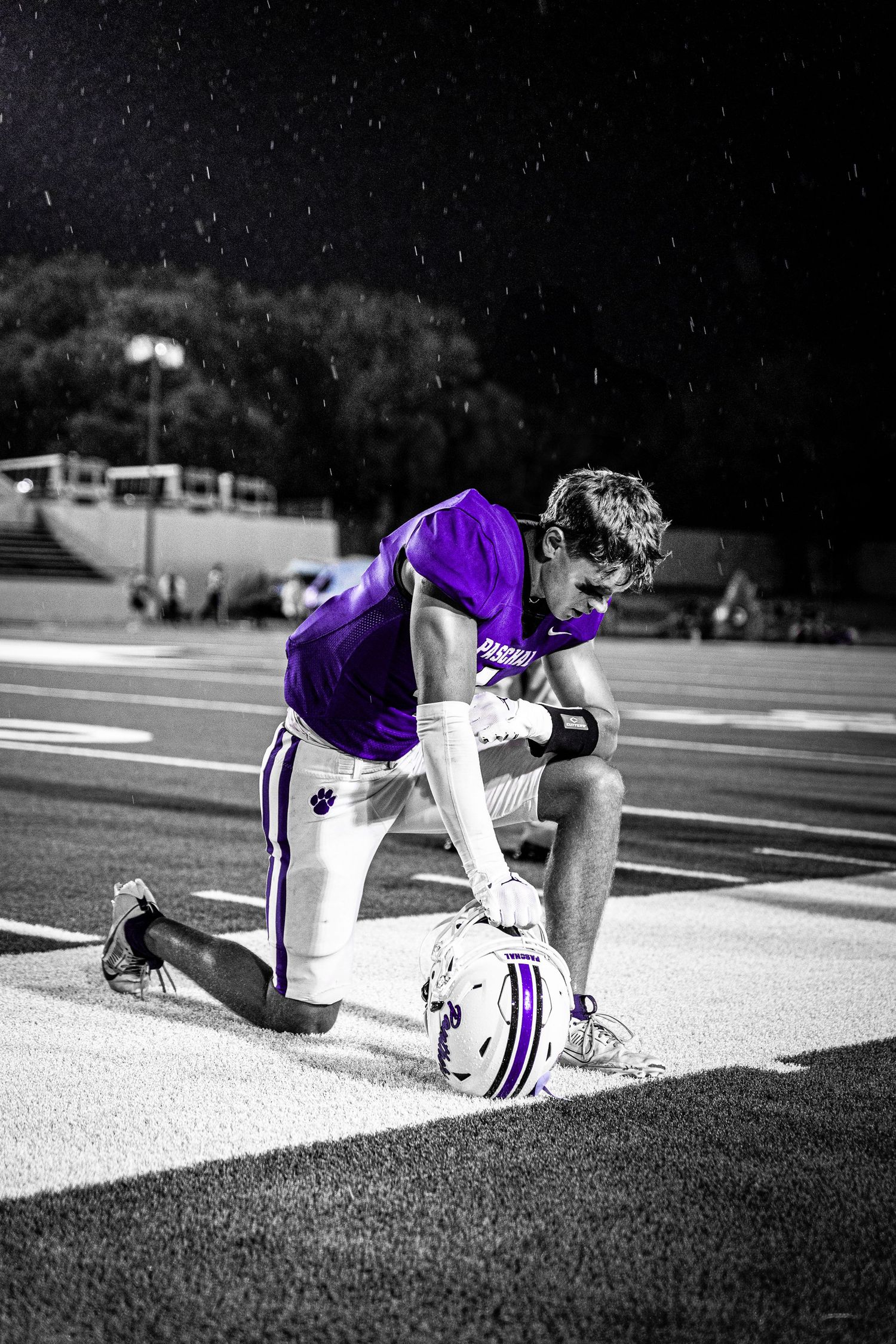 R.L. Paschal High School Varsity Football captain prays on Farrington Field before an opening game. The beginning of the purple reign.