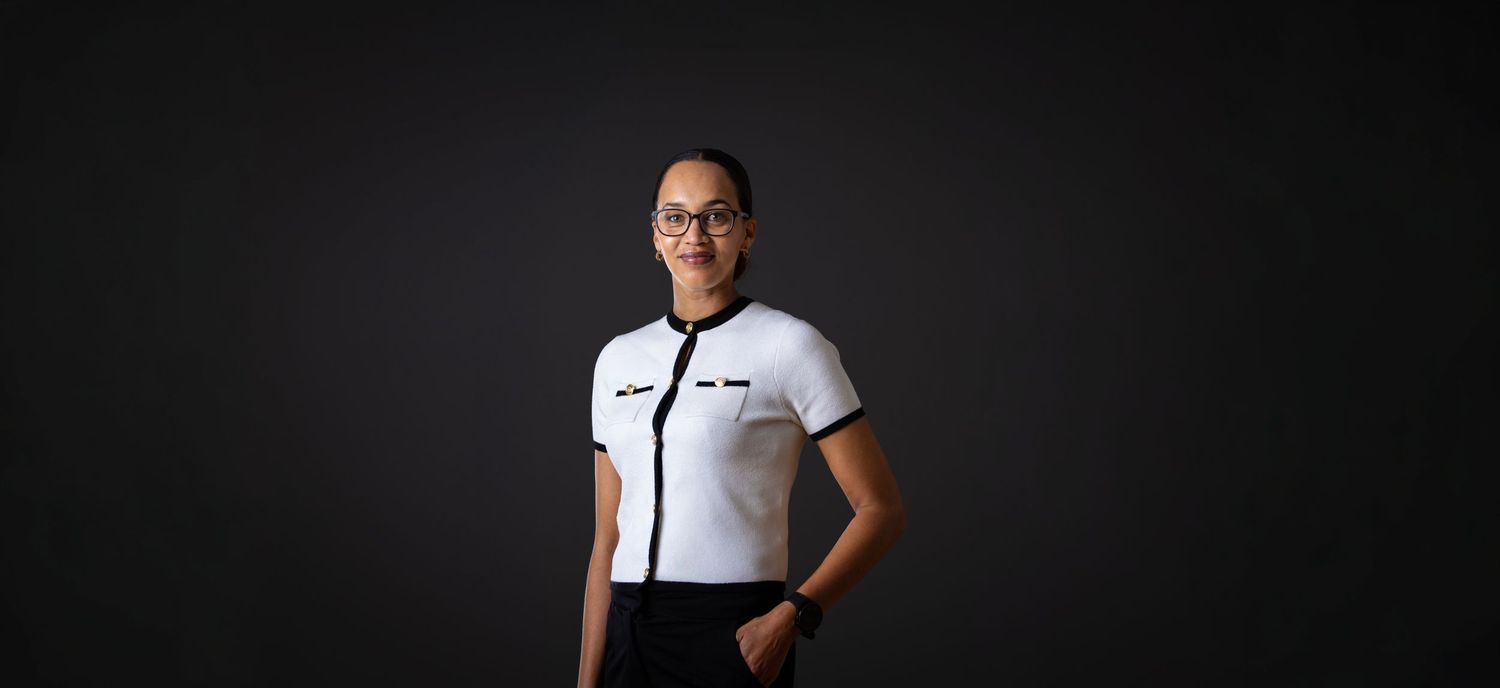 Professional studio portraits against a black background showcasing different poses and outfits.