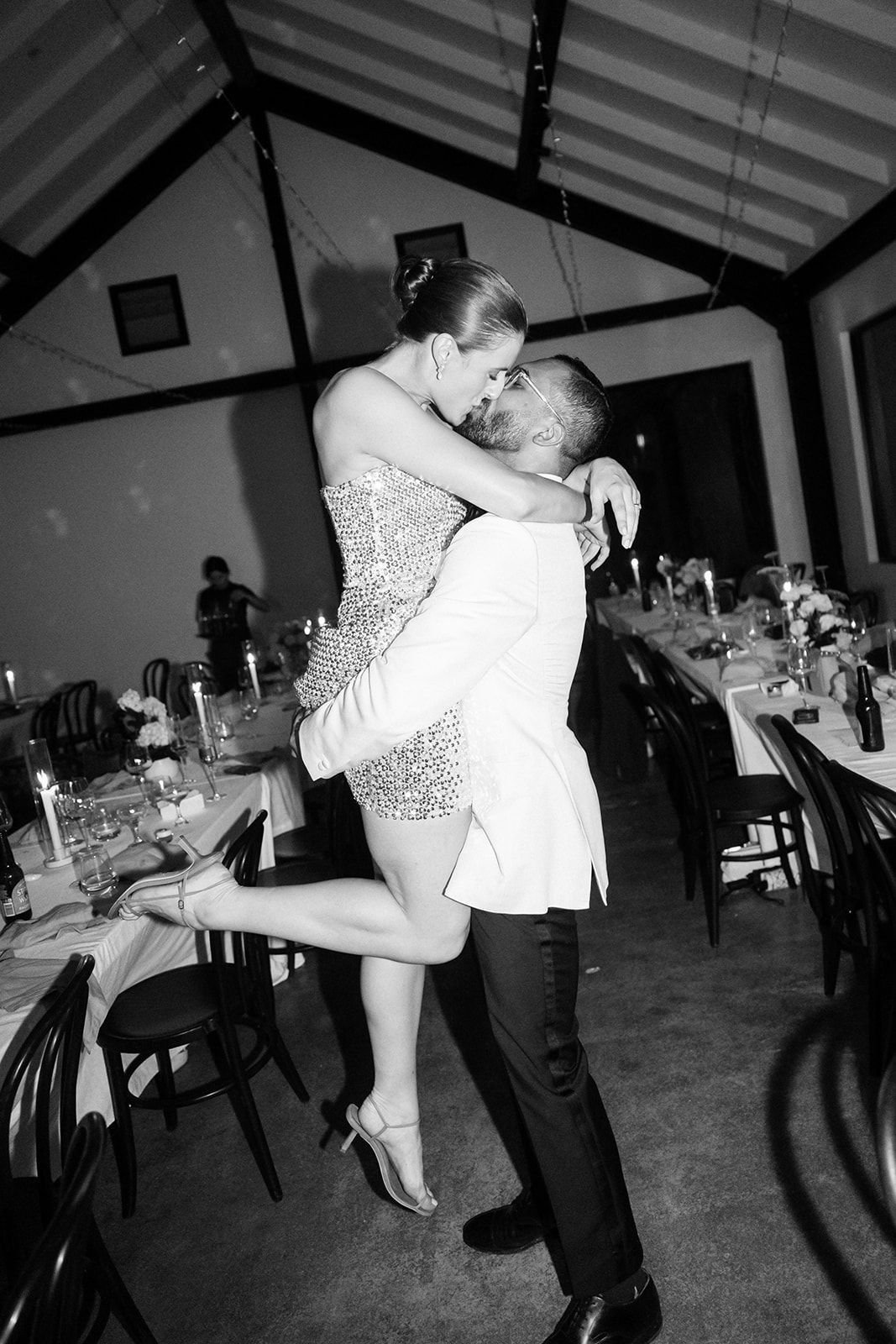 Beautiful black and white photo capturing an intimate dance moment at a wedding reception venue.