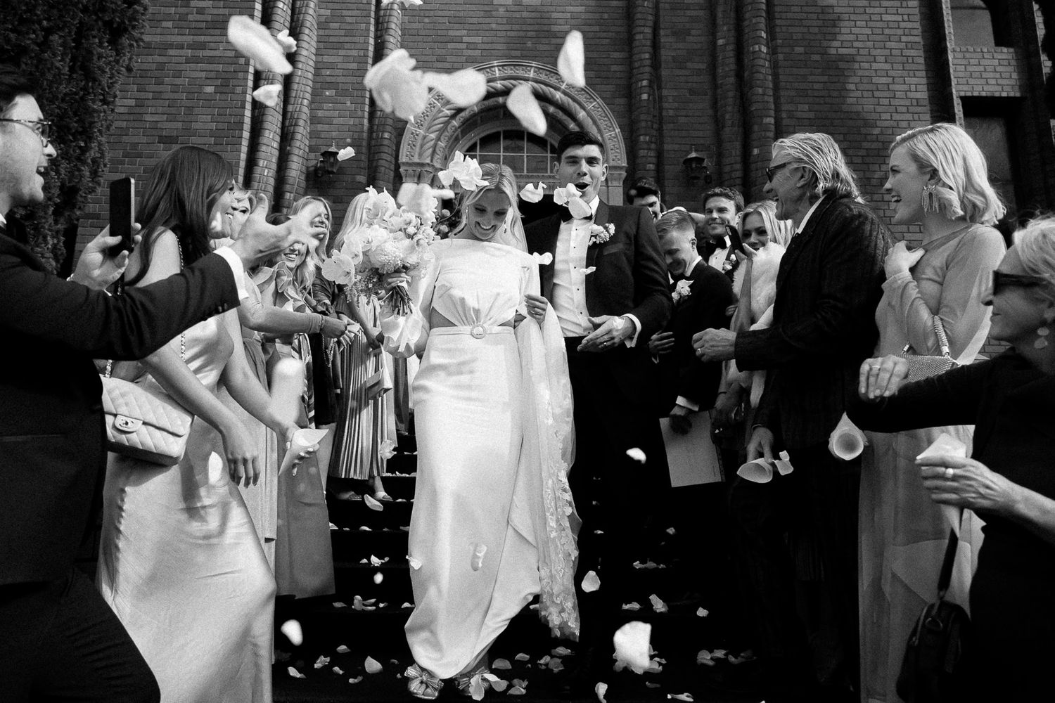 A black and white slideshow of multiple dancing couples during a celebration on the dance floor.