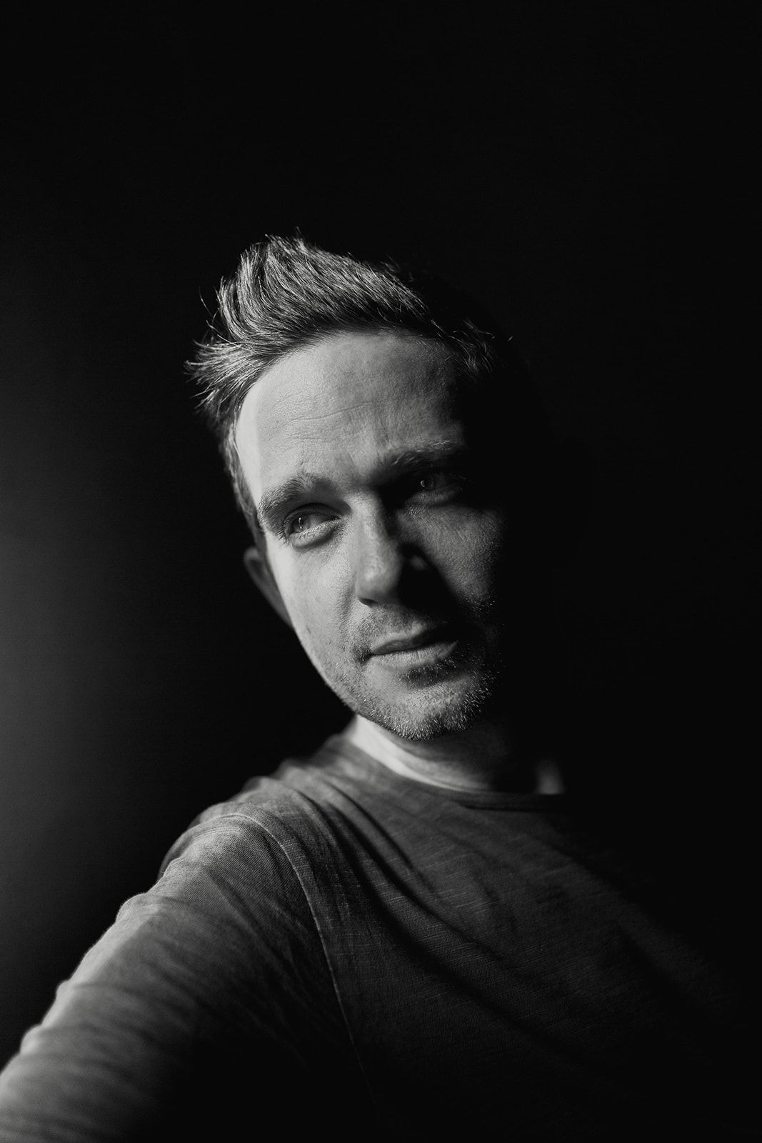 Black and white portrait sequence showing dramatic lighting and shadows across a person's face in multiple angles.