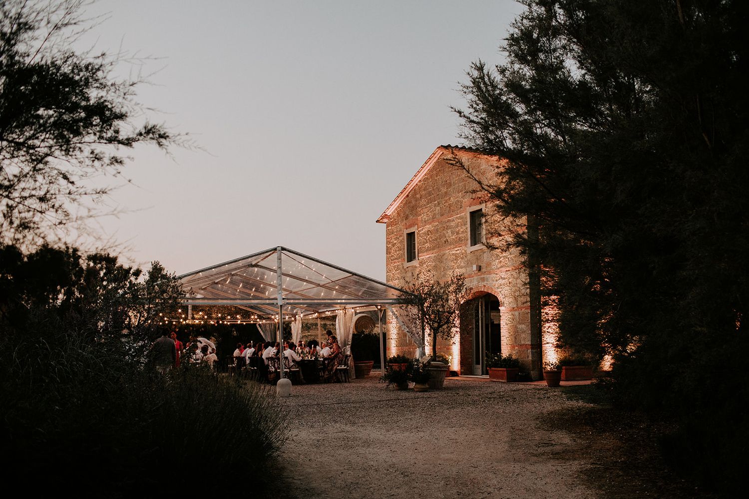 A series of dim panoramic shots showing a rustic stone church building exterior at dusk or twilight.
