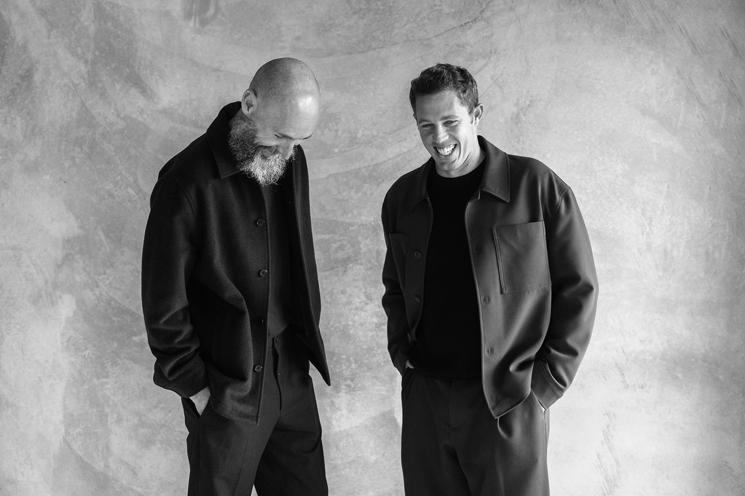 Black and white photo series showing different poses and expressions in a studio setting against a textured backdrop.