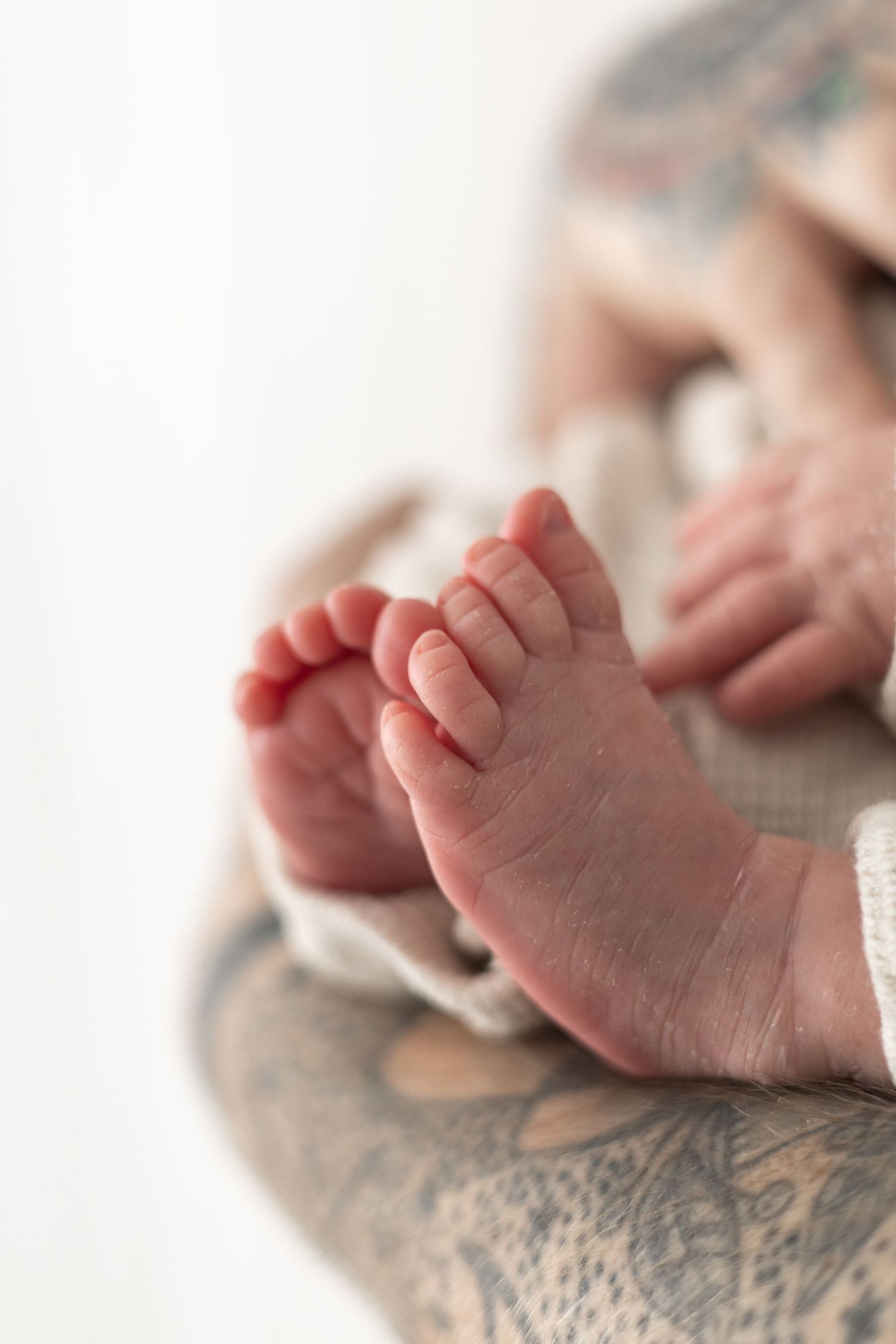 Newborn photography Nottingham baby close up tiny feet detail shot in dads arms
