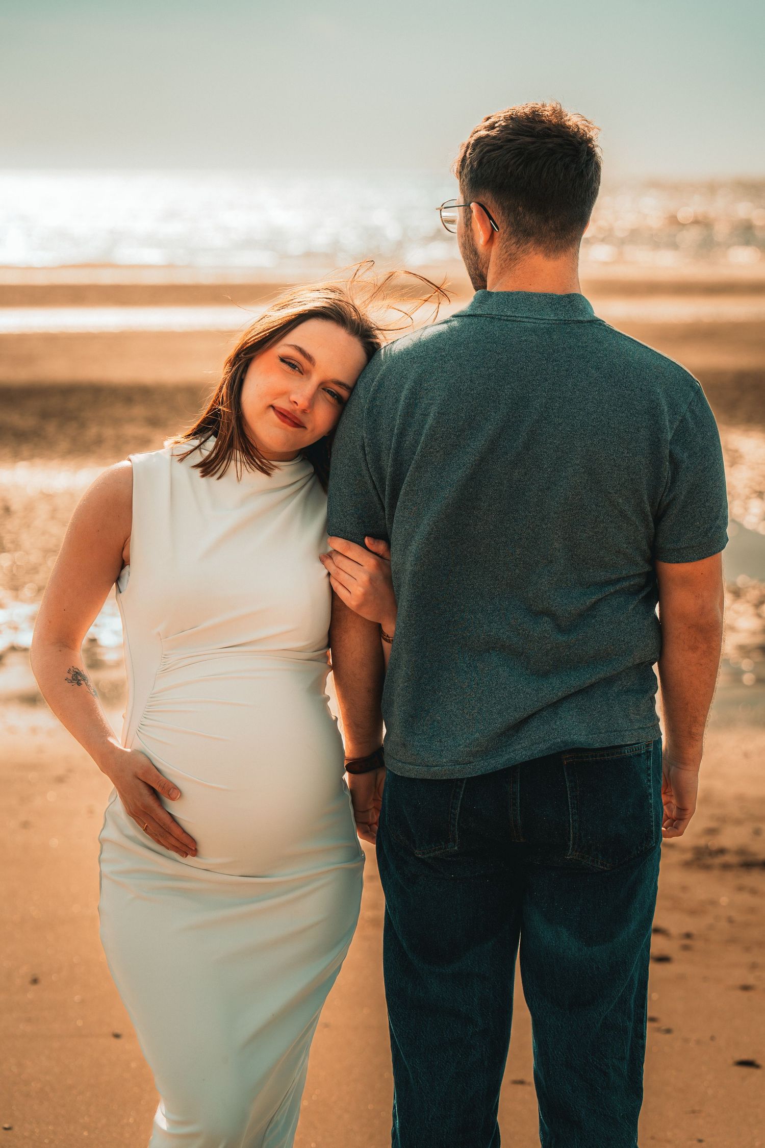 Portrait de grossesse sur la plage mettant en valeur la beauté de la maternité.