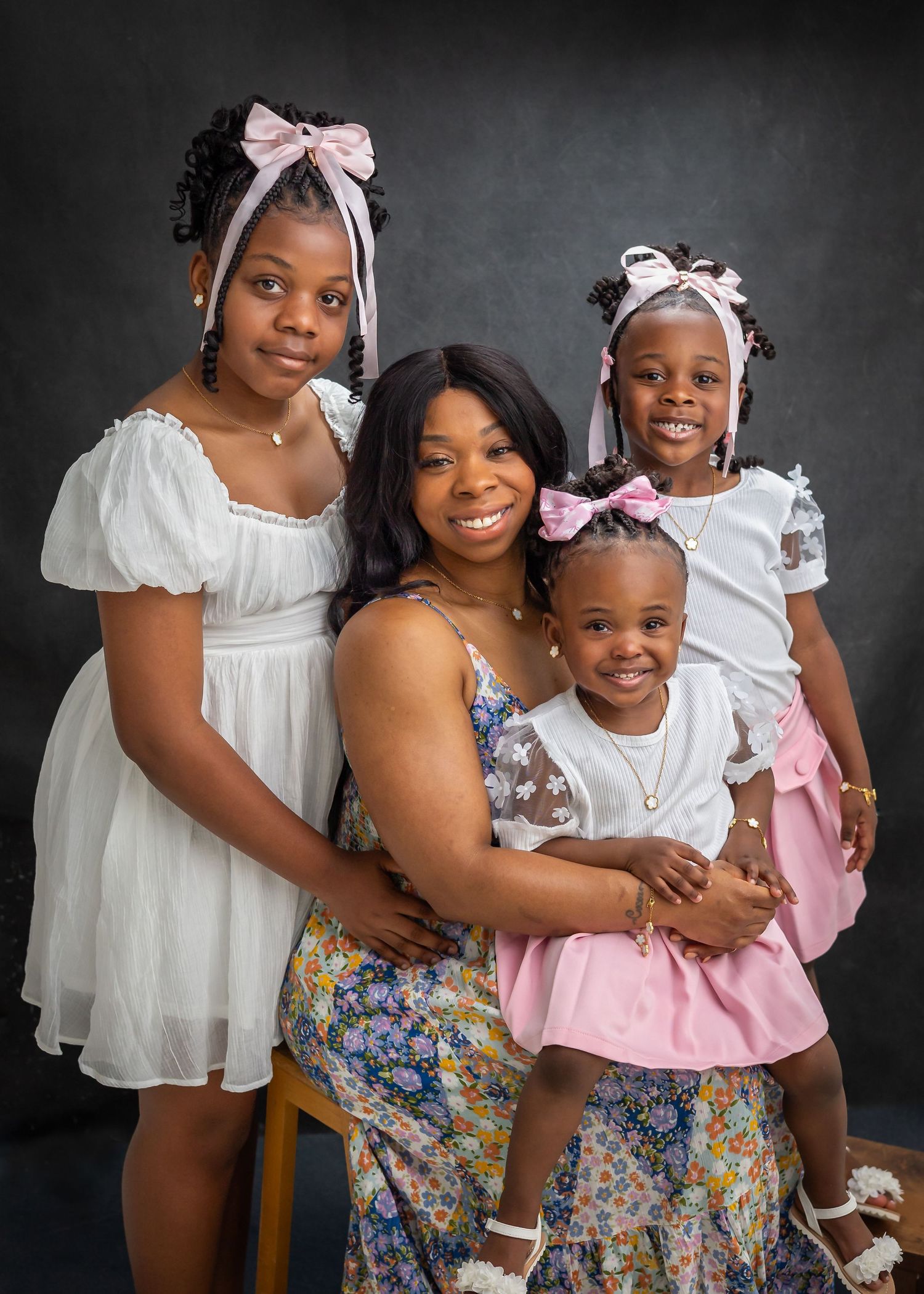 A heartwarming series of portrait photos showing loving embraces and smiles against a dark gray studio backdrop.