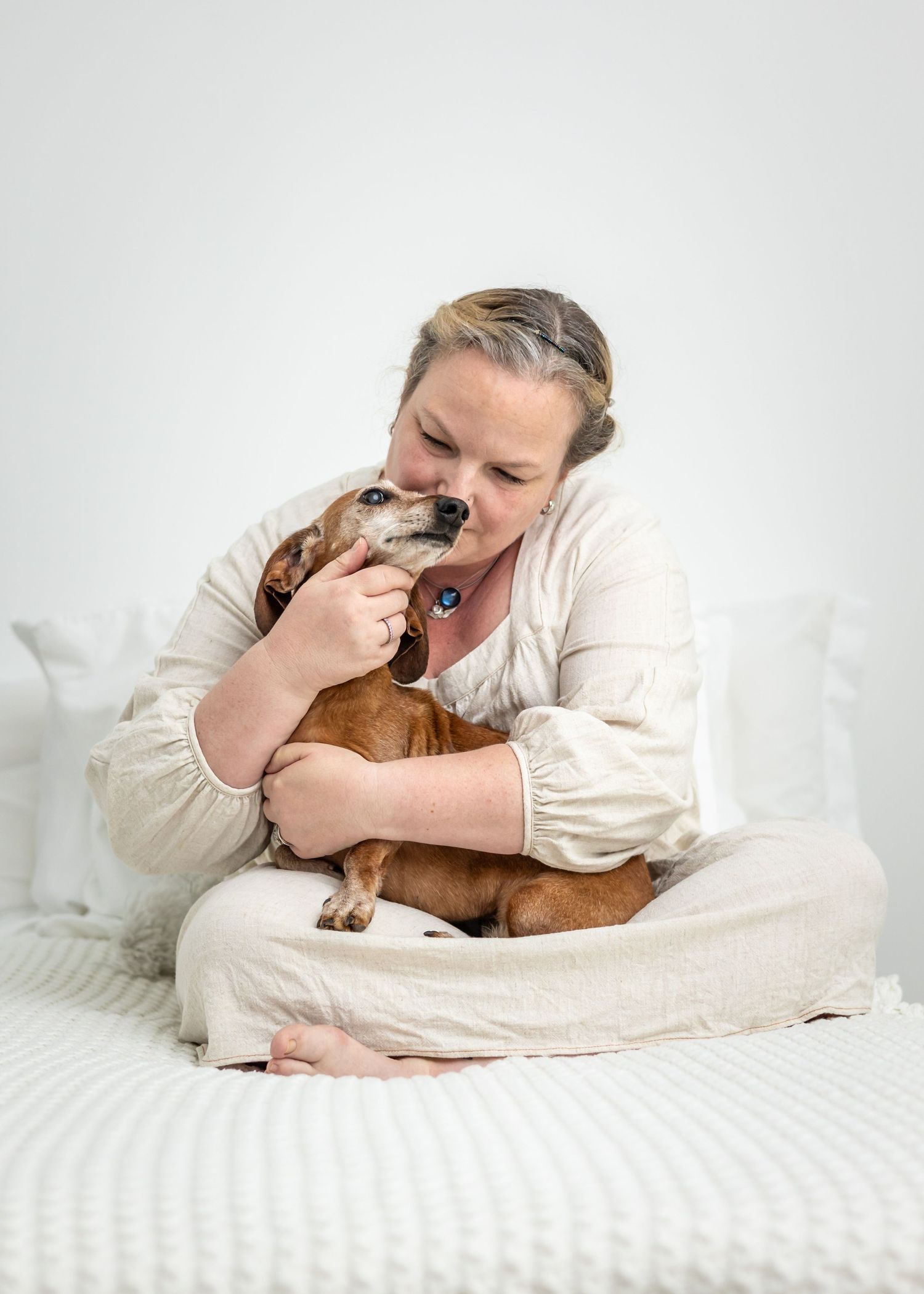 Woman and elderly small brown dachshund dog portrait session in Alabama studio.