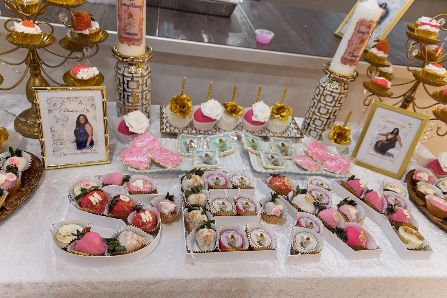 Luxurious dessert table display with pink and gold decorative elements.