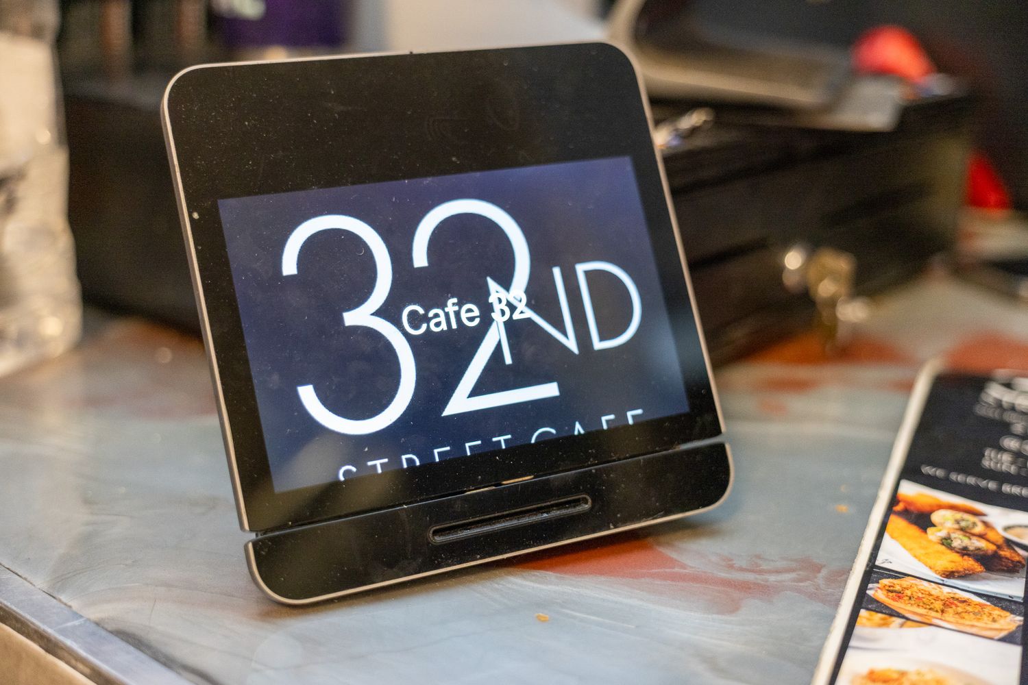 Digital clock display showing time on multiple electronic devices arranged in a row on a surface.
