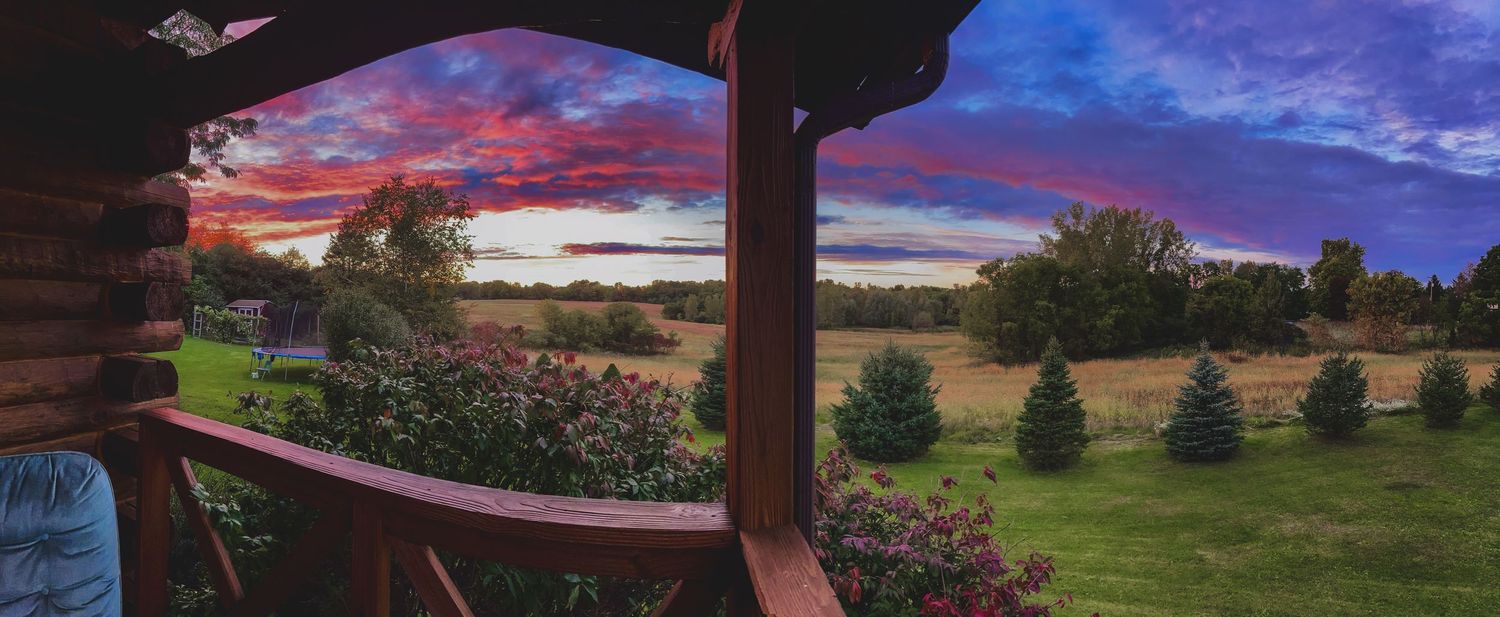 Dramatic pink sunset sky over a rural Finger Lakes New York landscape, homestead portrait photography location by Soft Wild Light.