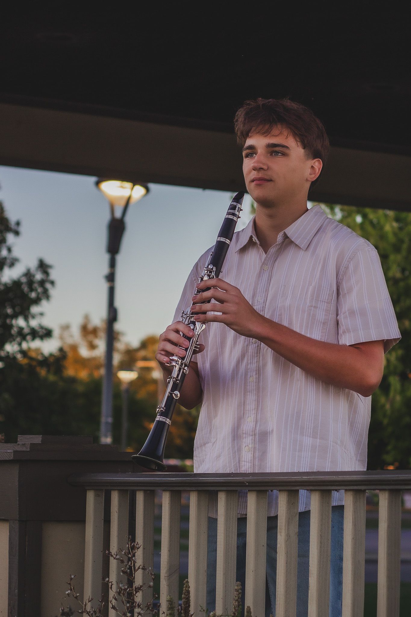 Senior portrait of a teenage boy playing a clarinet outdoors, natural light photography, Finger Lakes NY, Soft Wild Light