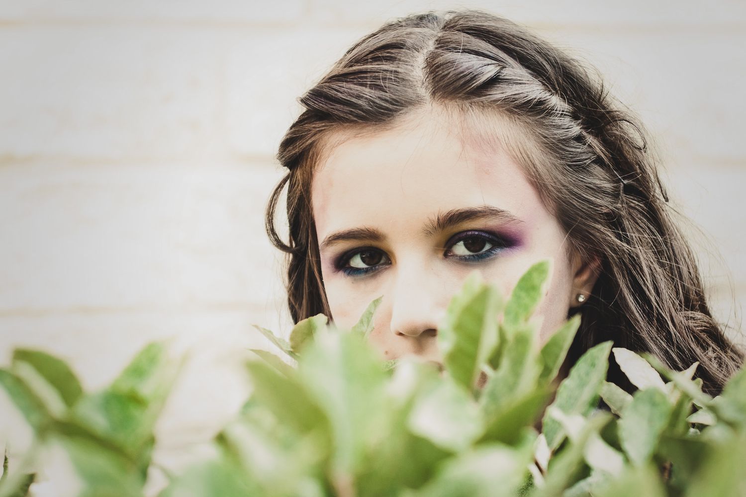 Artistic senior portrait of a teenage girl framed by green foliage, natural light photography, Finger Lakes NY, Soft Wild Light