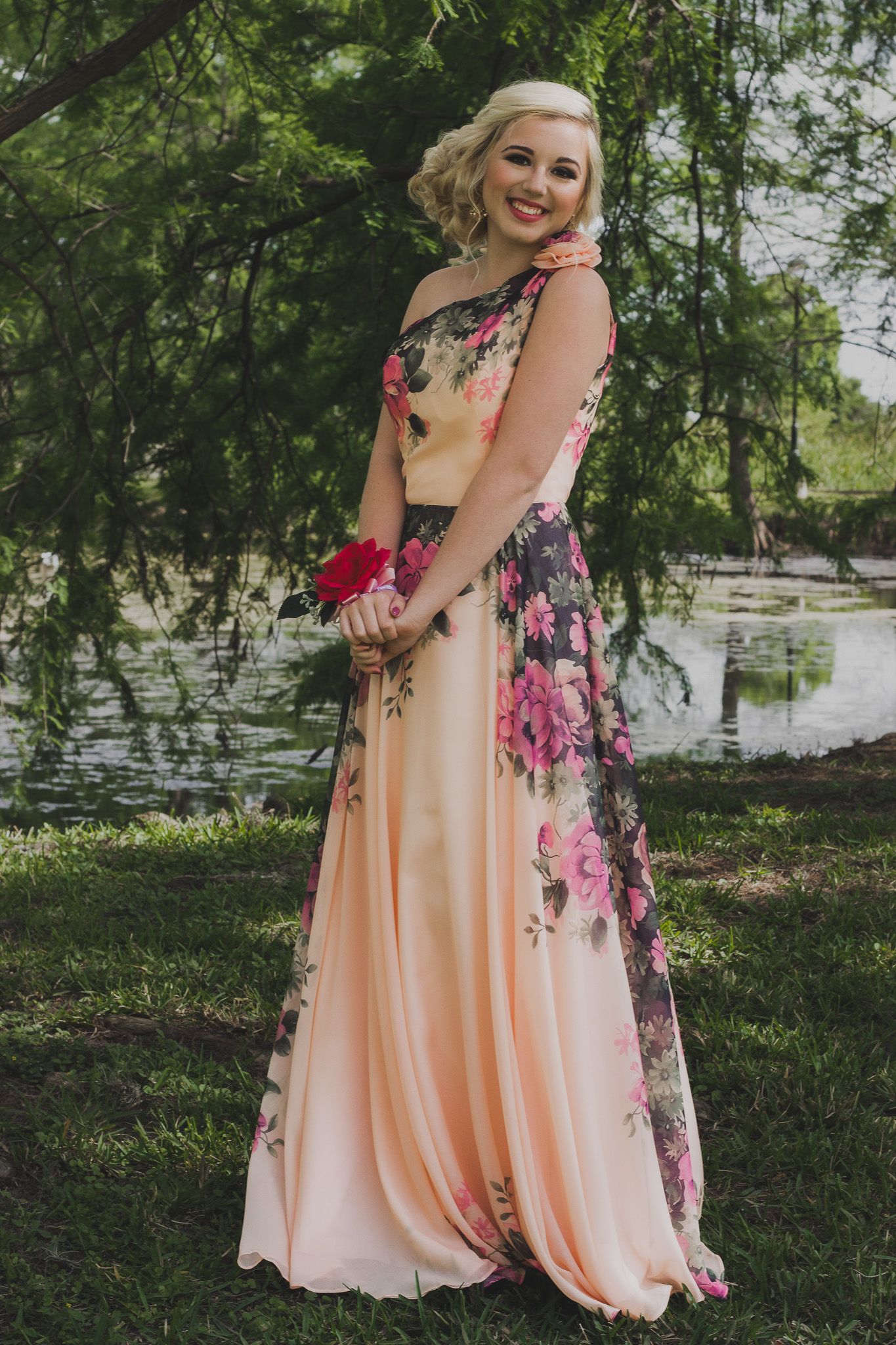 Senior prom portrait of a young woman in a floral gown outdoors, natural light photography, Finger Lakes NY, Soft Wild Light.