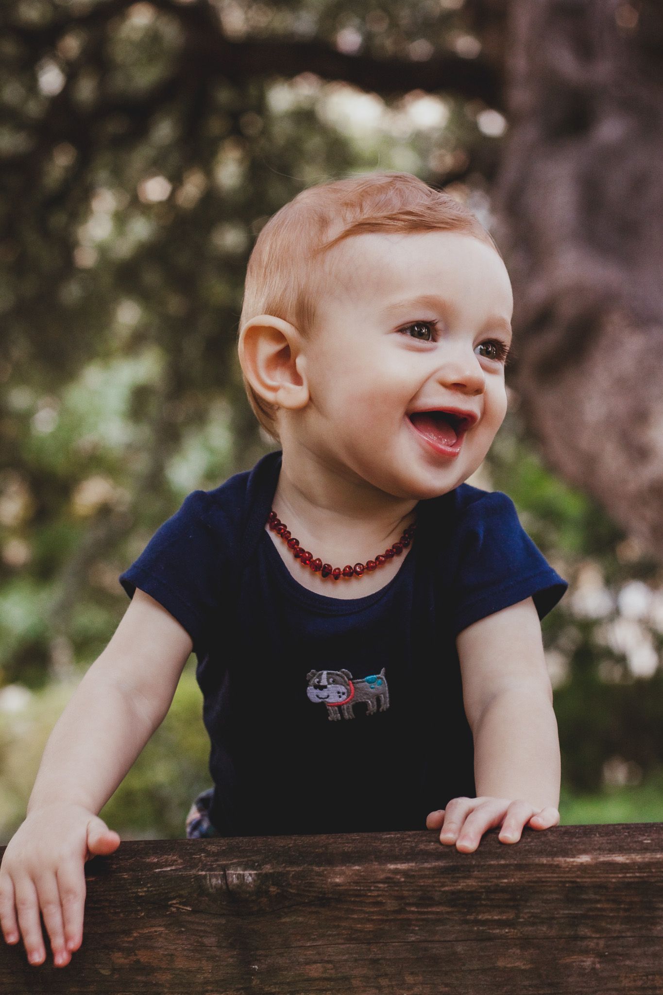 Laughing baby in a candid outdoor portrait, natural light child photography, Finger Lakes NY, Soft Wild Light.
