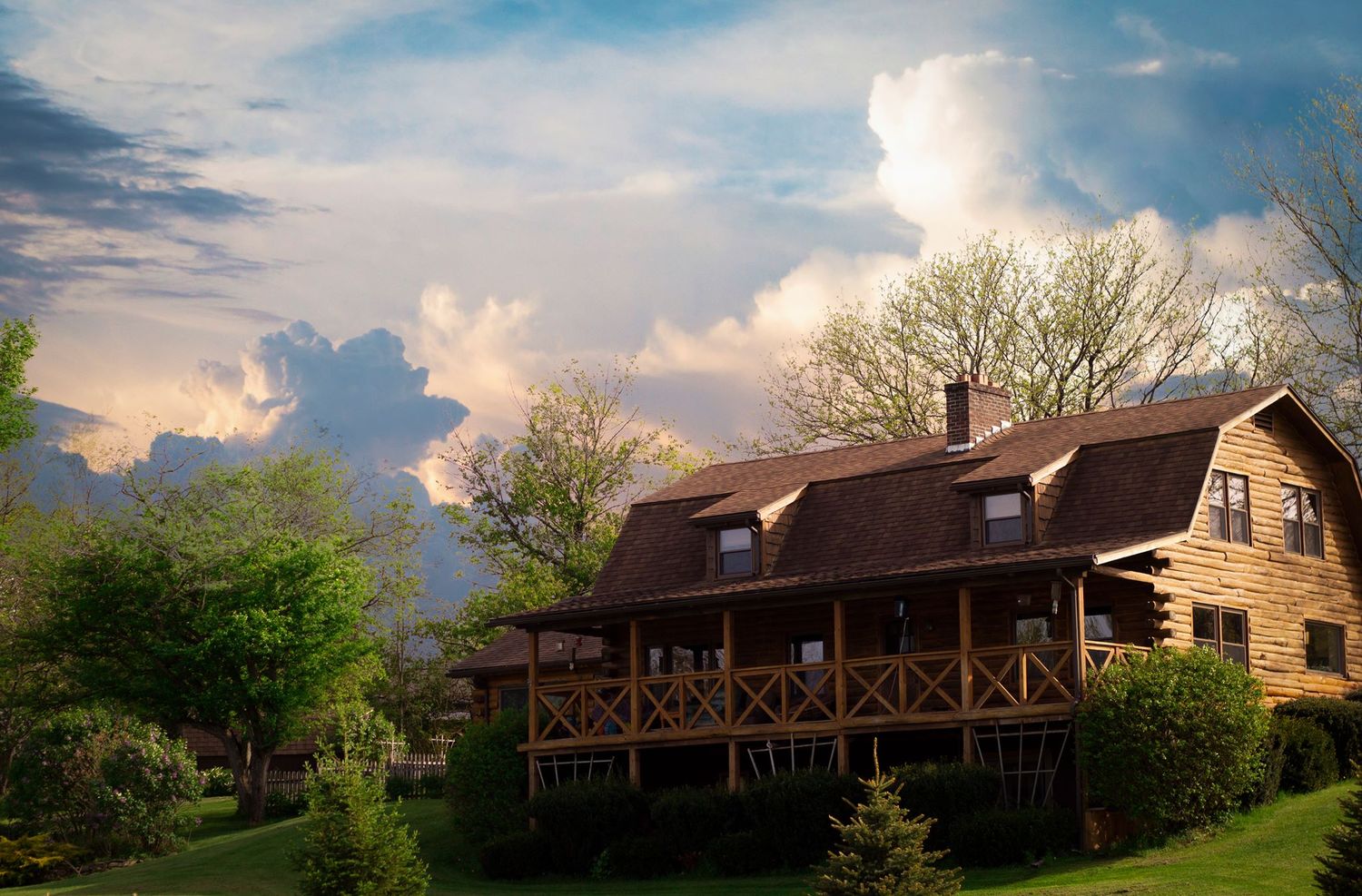 Charming farmhouse cottage, log cabin, under dramatic cloudy sky, Finger Lakes New York homestead photography by Soft Wild Light.