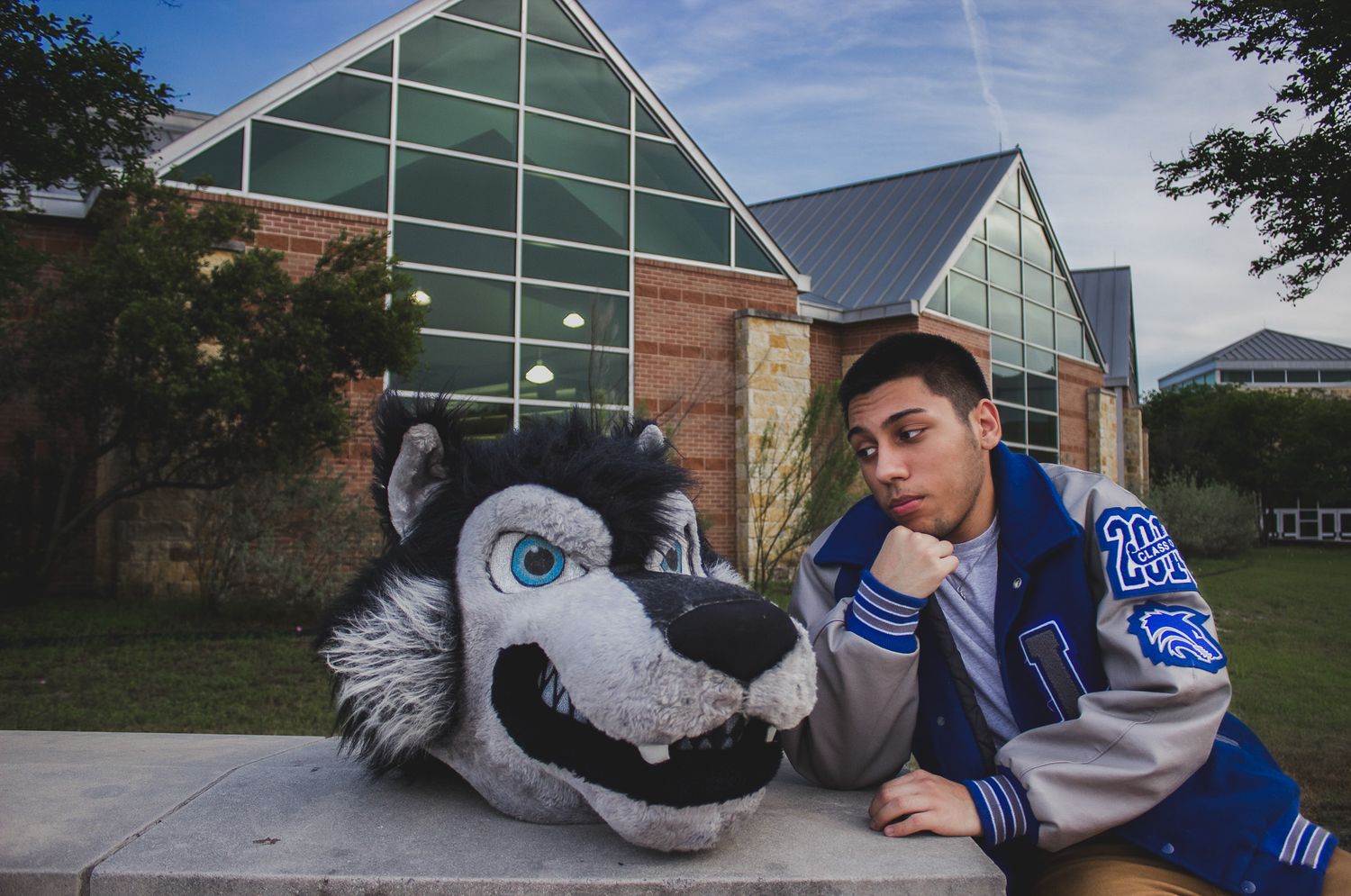 Teenager with wolf mascot outdoors, natural light candid senior portrait session, Finger Lakes NY, Soft Wild Light Photography.