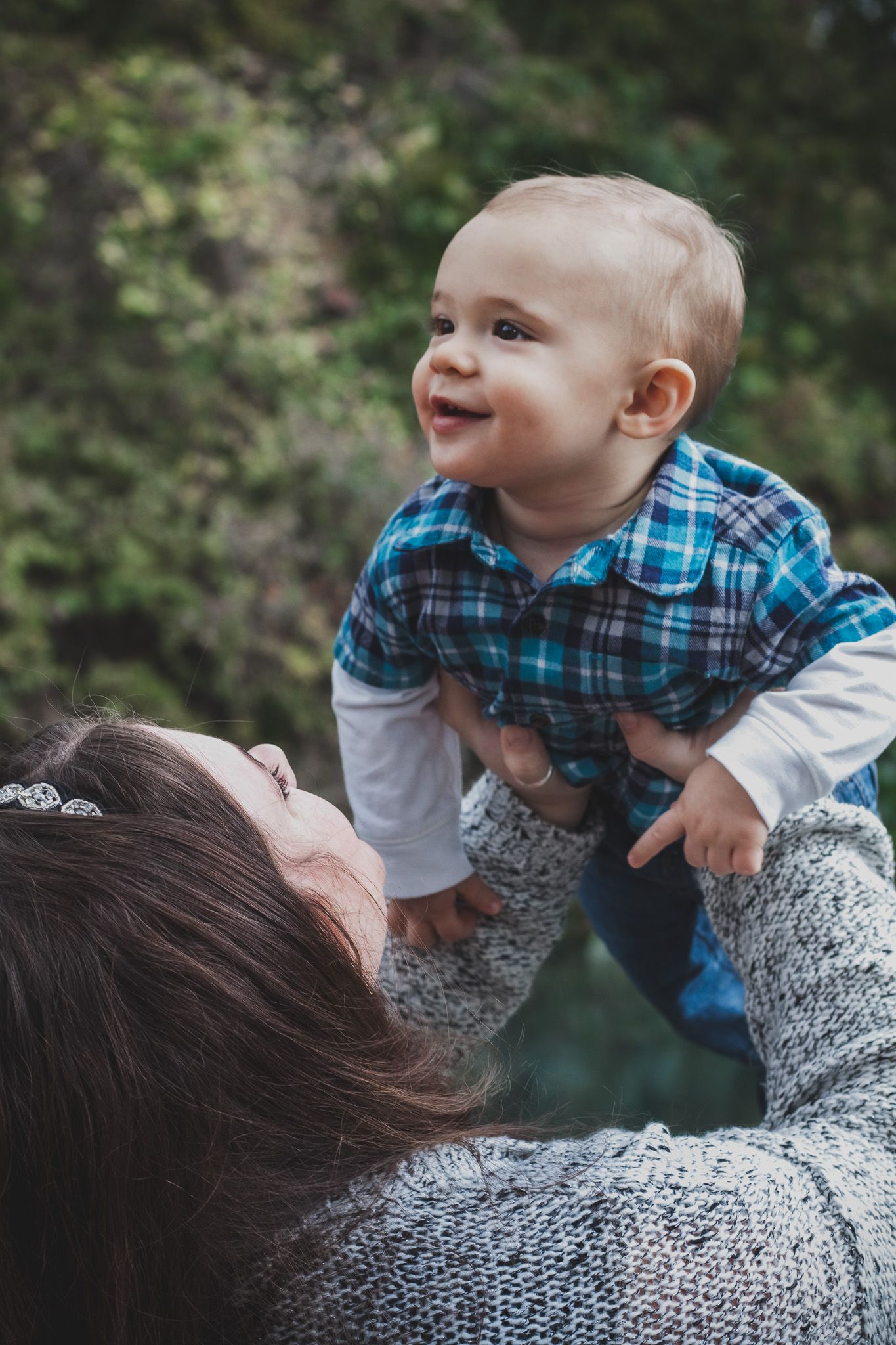 Mother lifting a laughing baby overhead, candid natural light portrait, Finger Lakes New York, Soft Wild Light.