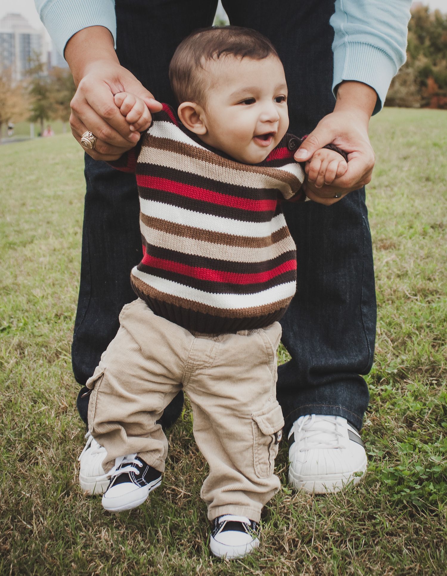 Parent holding toddler's hands while learning to walk on grass, candid family portrait, Finger Lakes NY, Soft Wild Light