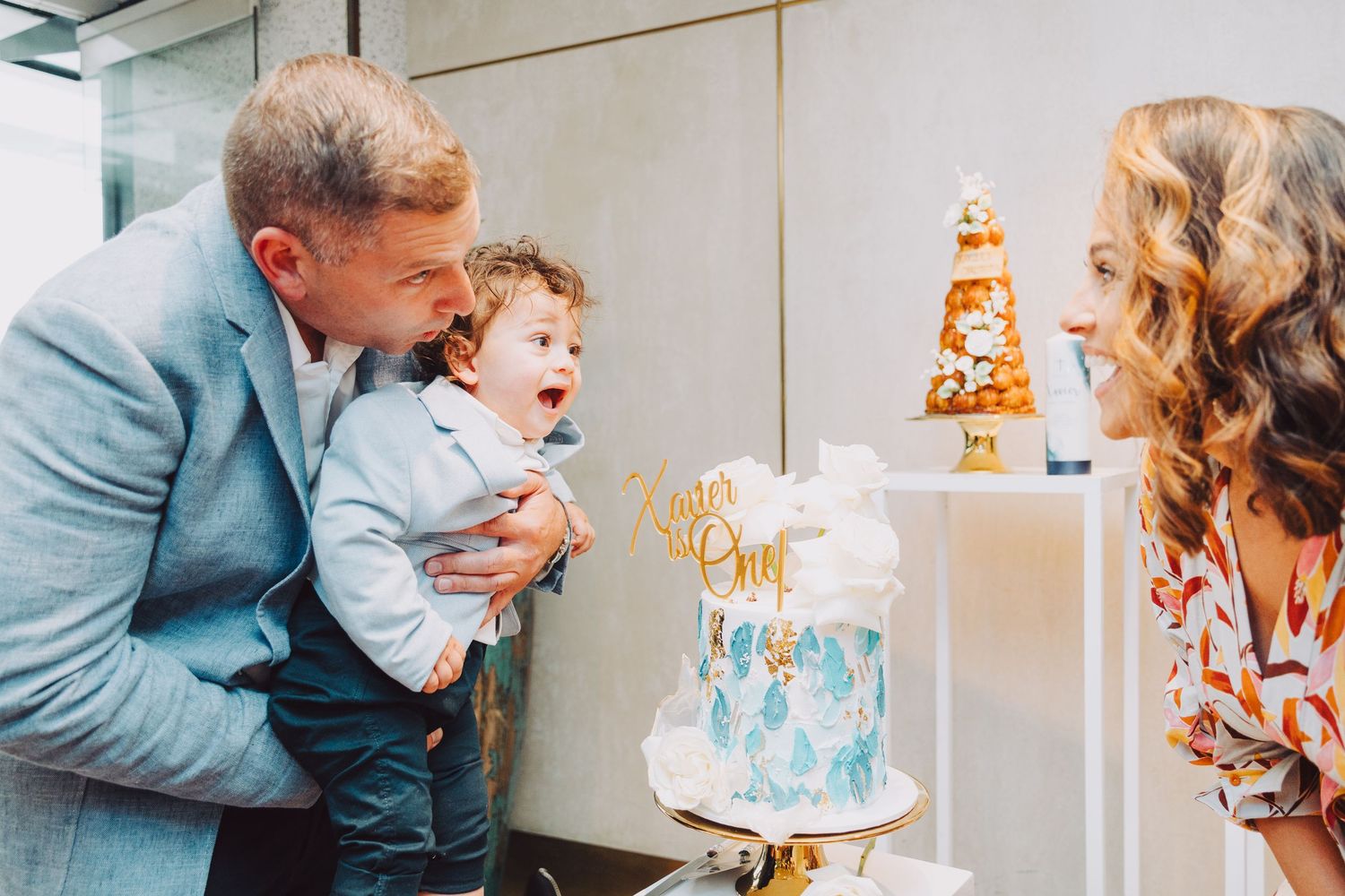 A series of sweet moments captured during a cake smash photoshoot with a baby celebrating their first birthday.