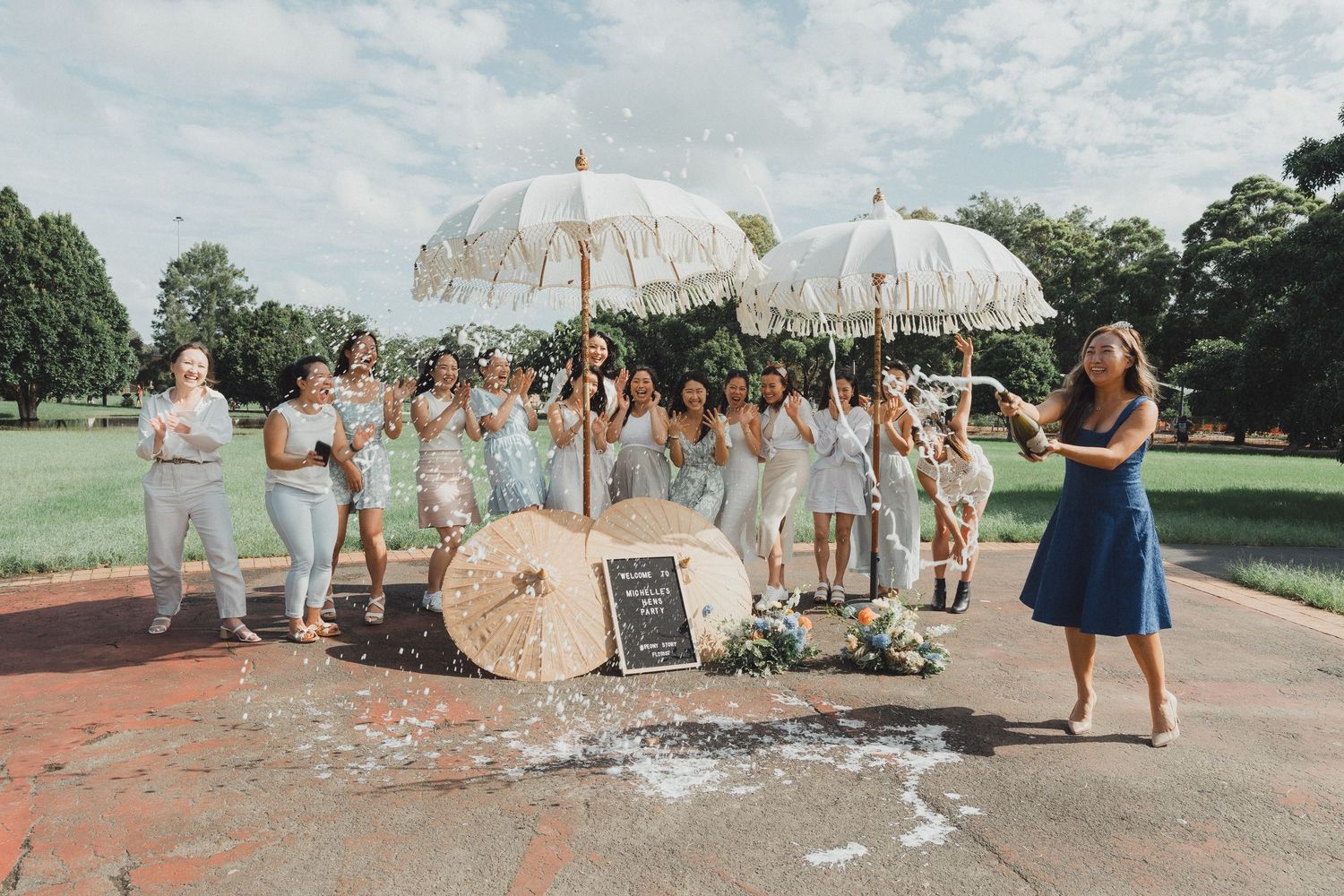 A collage of outdoor wedding celebration photos showing parasols, dancing, and joyful moments in a sunny garden setting.