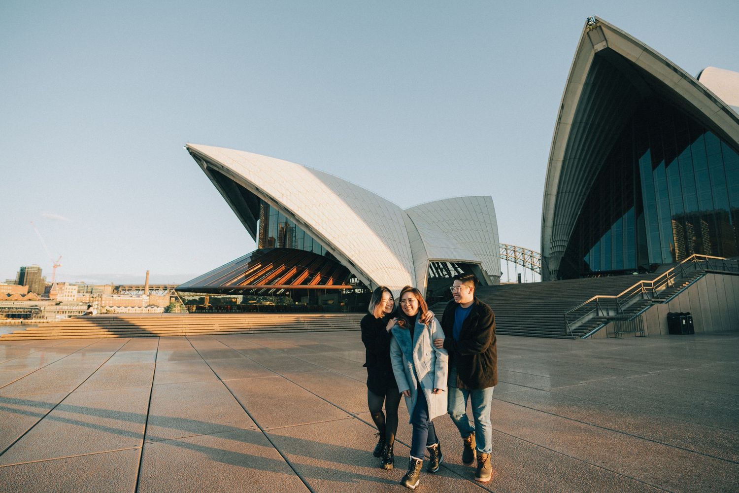 People explore the iconic TWA Flight Center terminal at JFK Airport with its distinctive curved architecture at sunset.