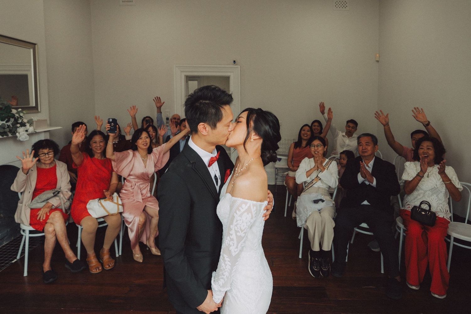 Wedding guests dance and celebrate together during a lively reception party on the dance floor.
