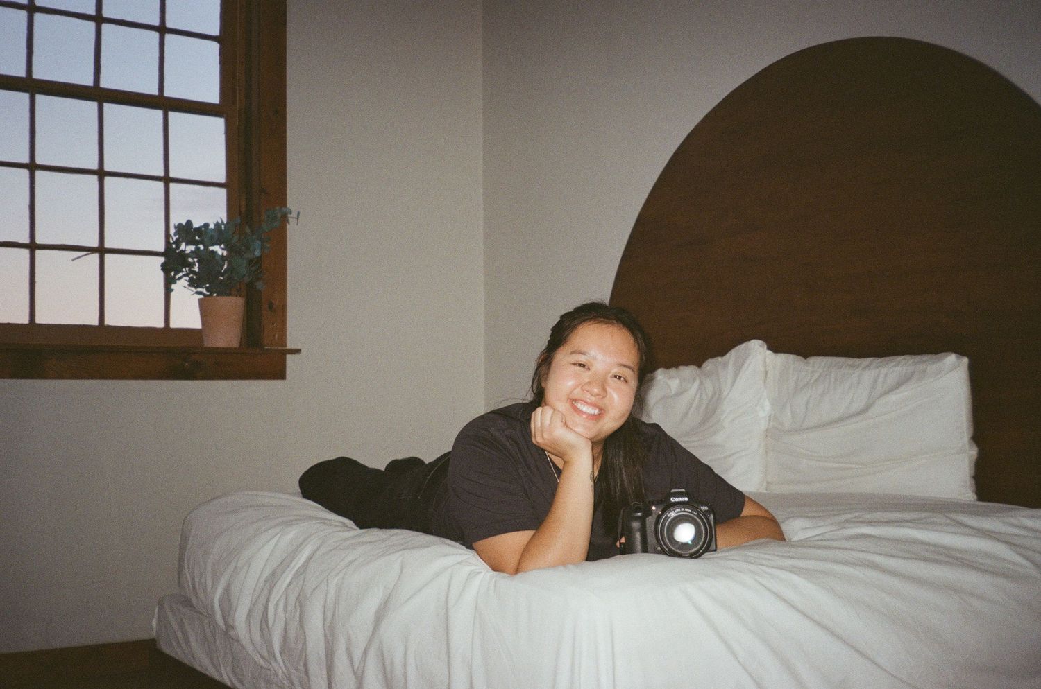 A series of six similar photos showing someone lying on a white bed with a camera.