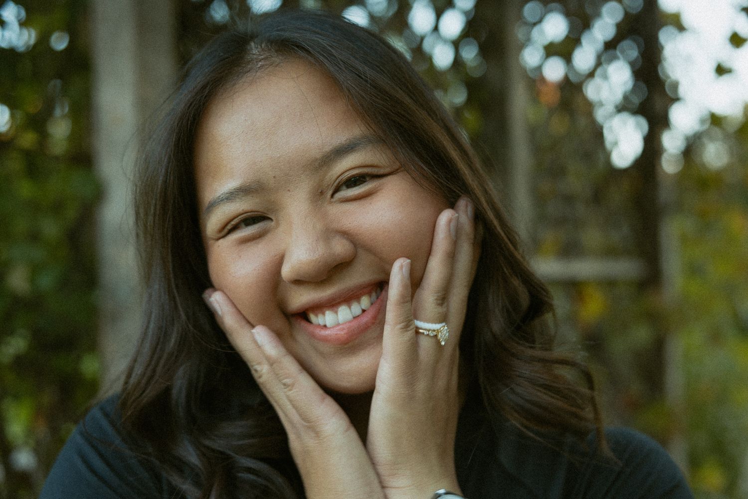 A series of candid outdoor portrait photos showing genuine laughter and joy against a natural green background.
