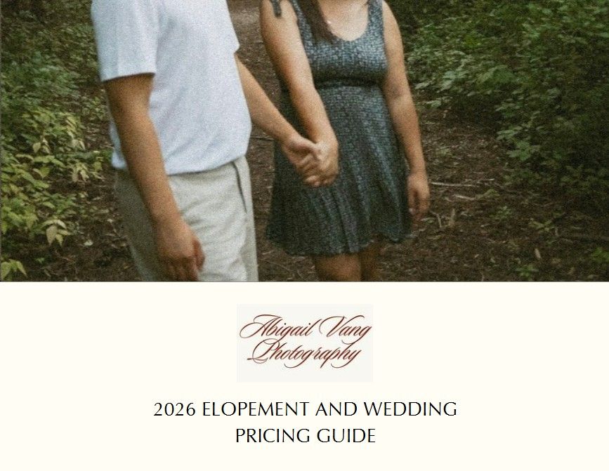 Couple walking hand in hand through a lush green forest path during an outdoor engagement photo session.