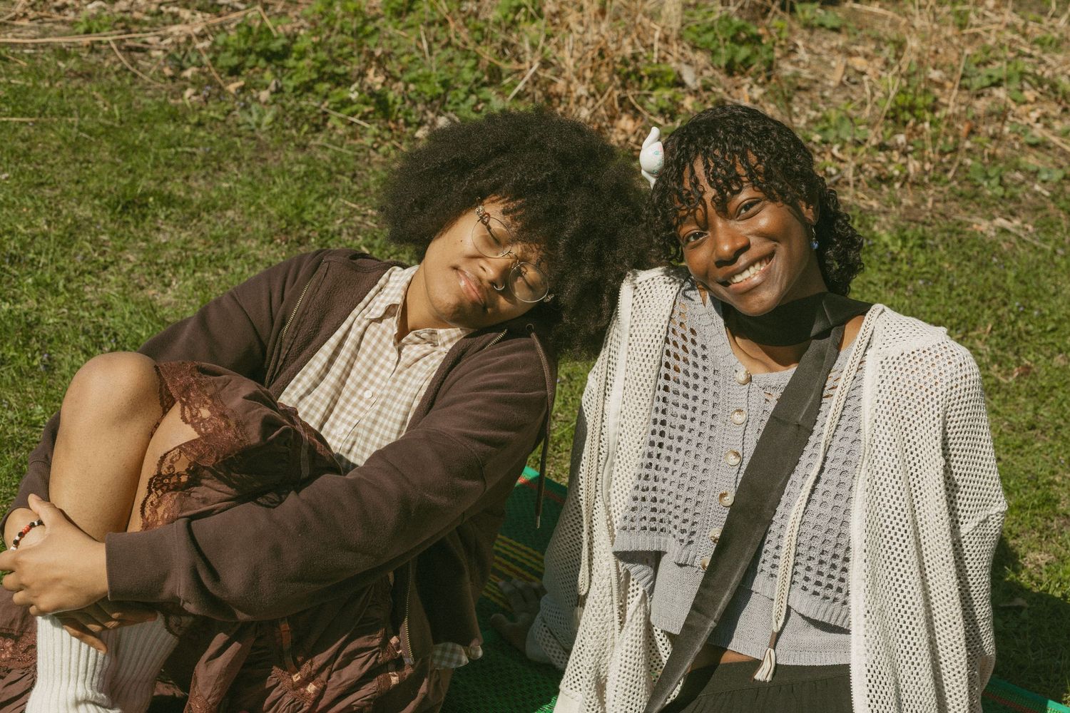 Diverse group of friends sharing joyful moments together outdoors on a sunny day.