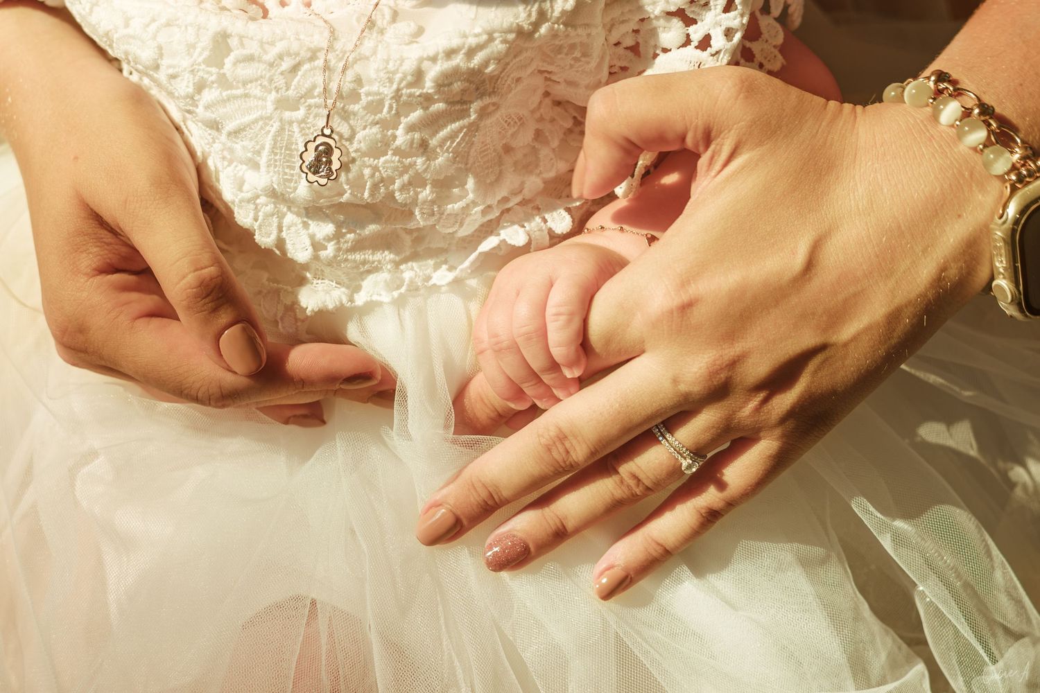Close-up of hands placing a wedding ring on a bride's finger, symbolizing marriage and love.