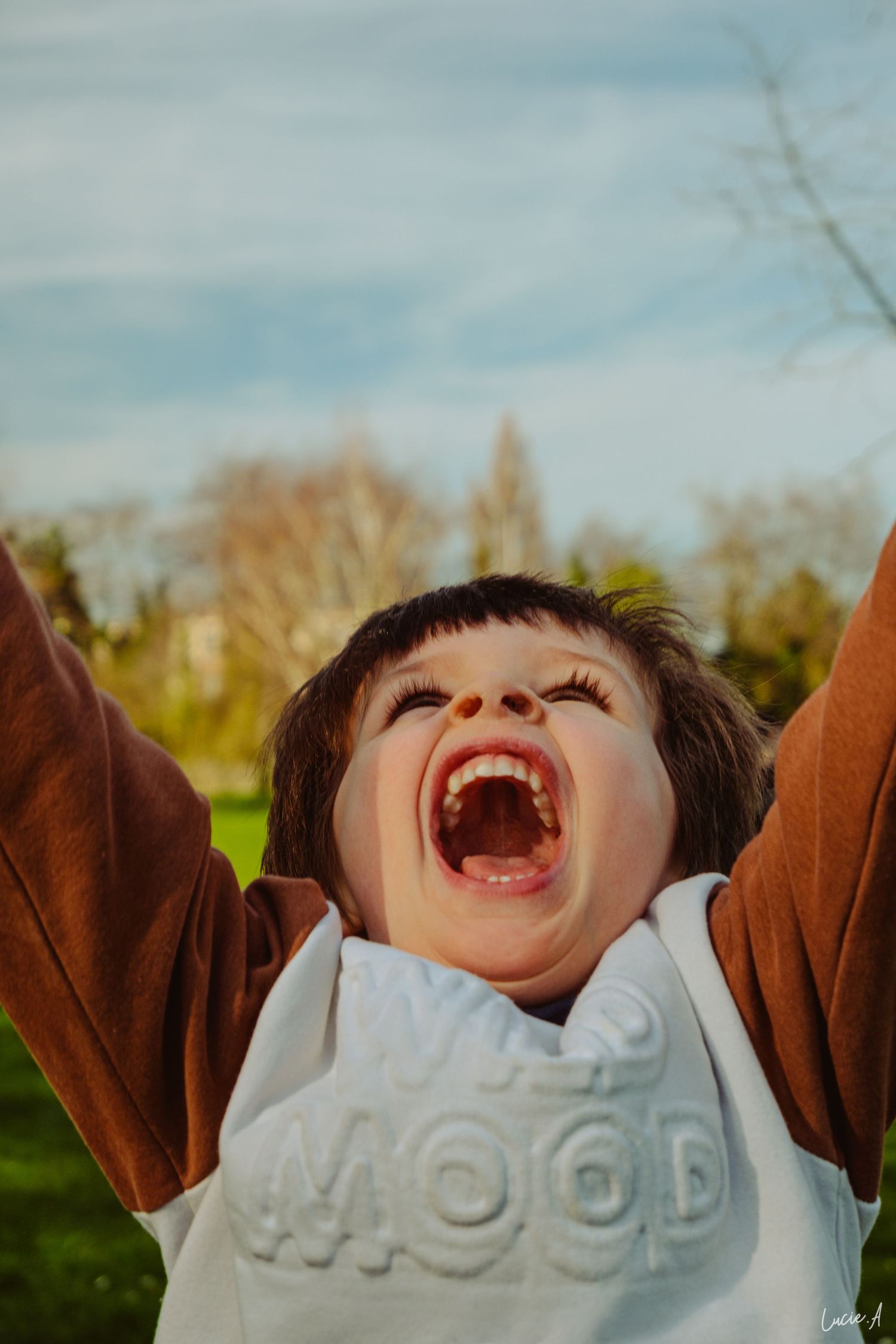 Enfant souriant en plein mouvement lors d’une séance famille à Ronchin