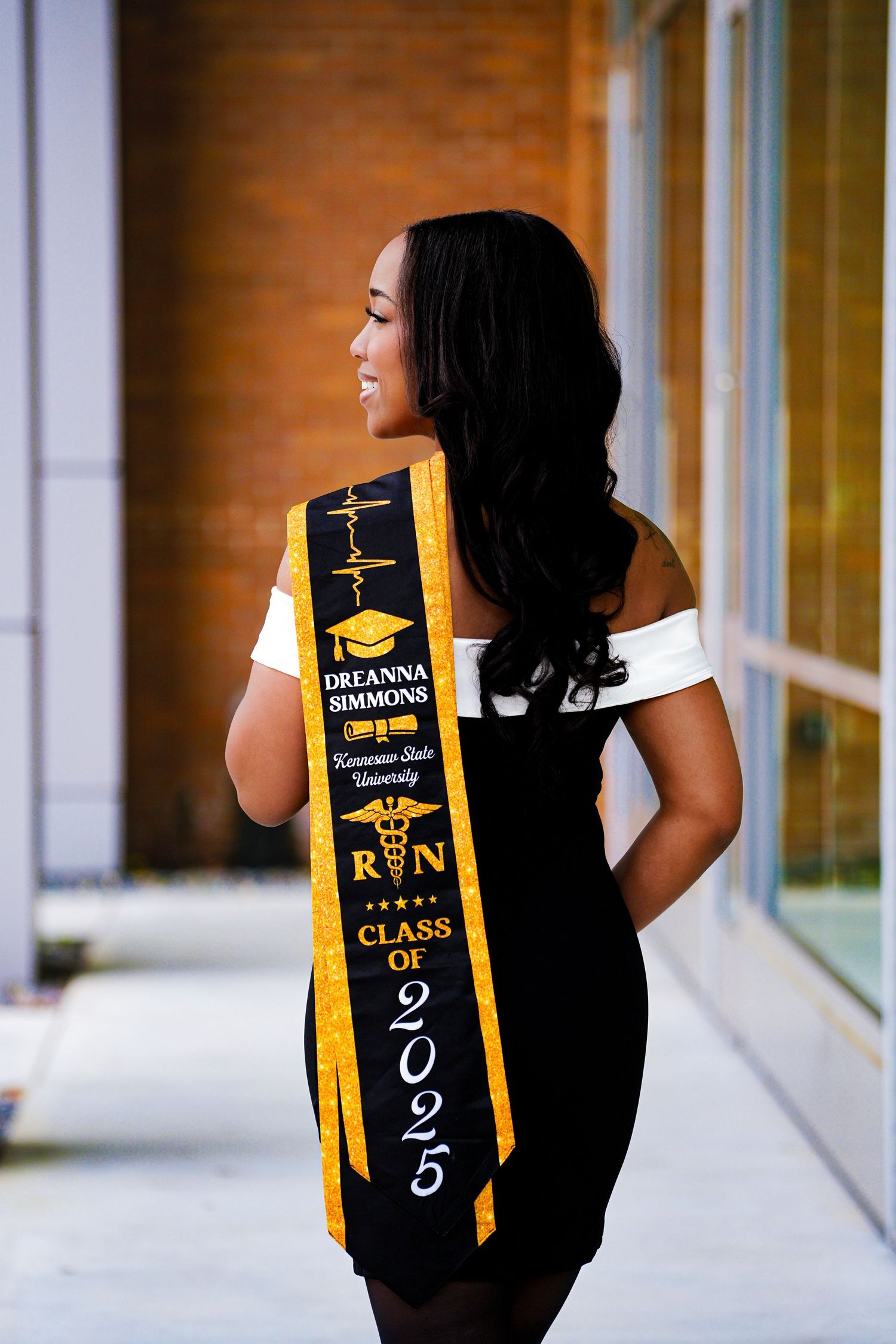 Back view of nursing graduate sash reading Dreanna Simmons Kennesaw State University RN Class of 2025.