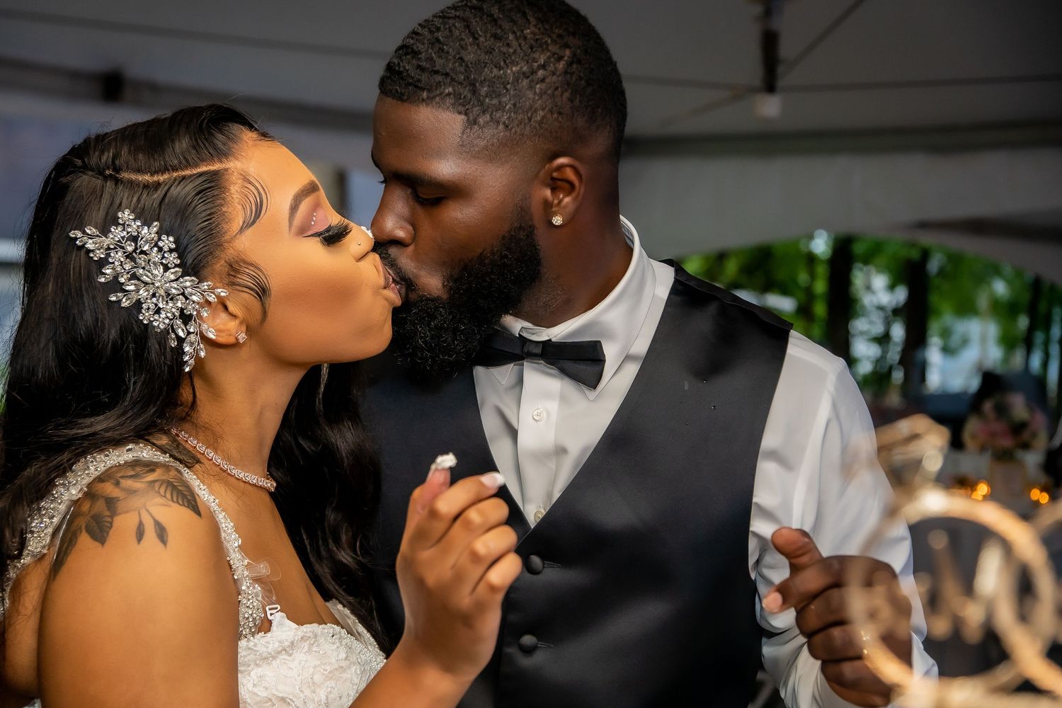 Bride and groom share a romantic kiss during their wedding reception dance.