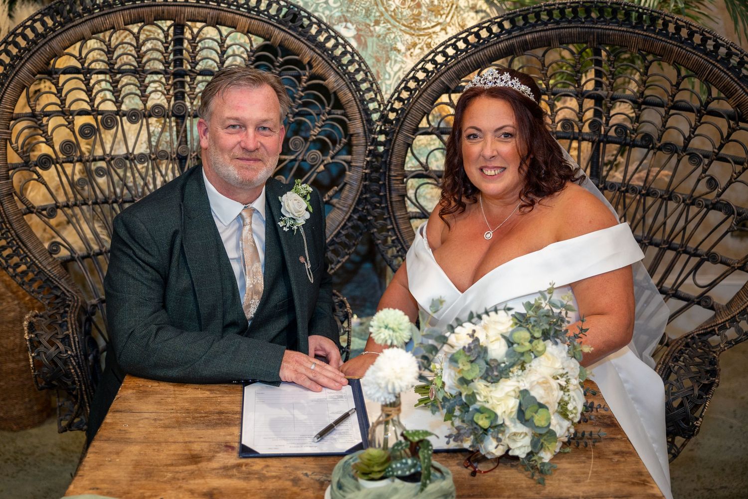 Bride and groom sign wedding register at Runa Farm, elegant indoor ceremony, romantic venue moment captured