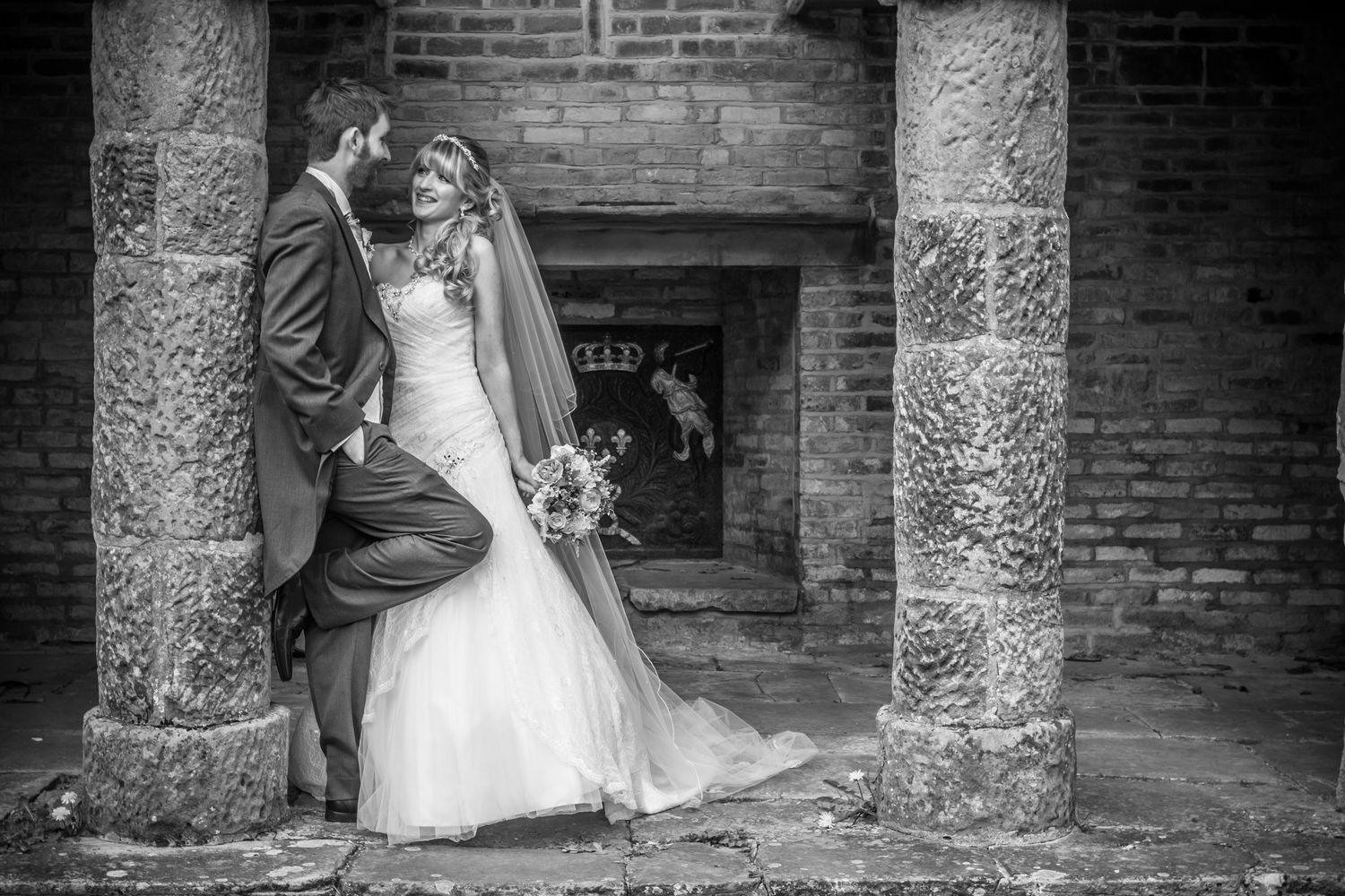 Bride and groom share a romantic moment at Redworth Hall Hotel, elegant black and white wedding portrait with classic architecture