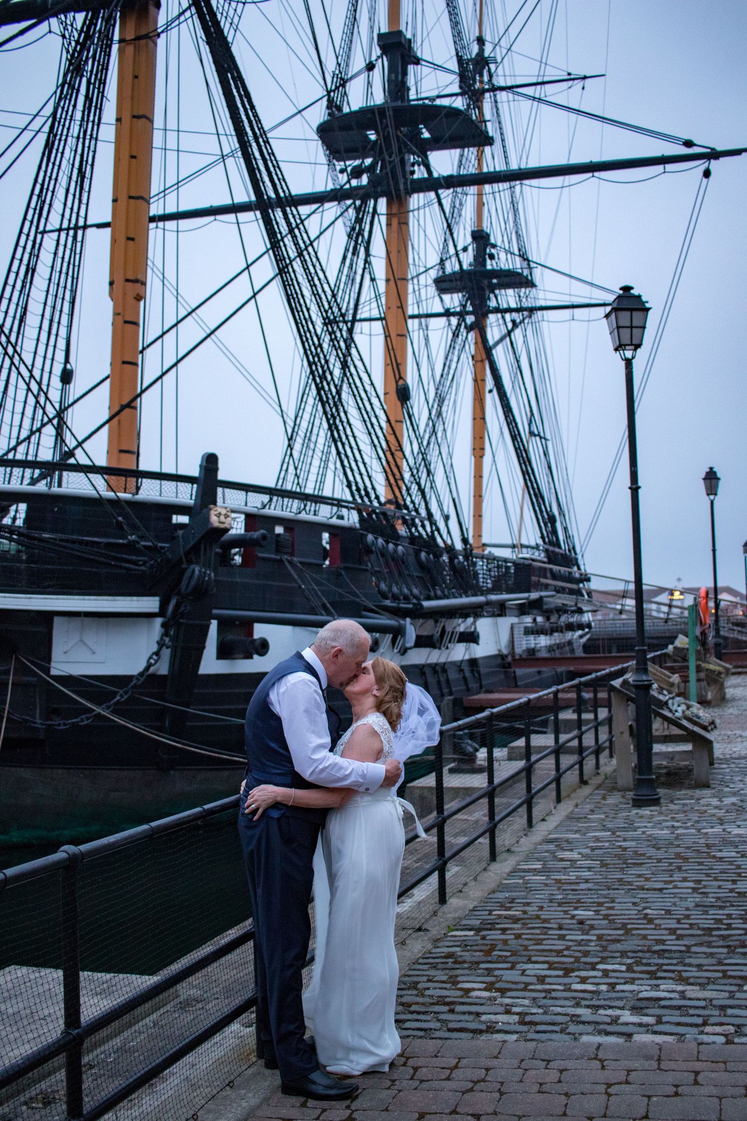 Bride and groom kiss by HMS Trincomalee in Hartlepool, a unique North East wedding venue with historic maritime charm and stunning views