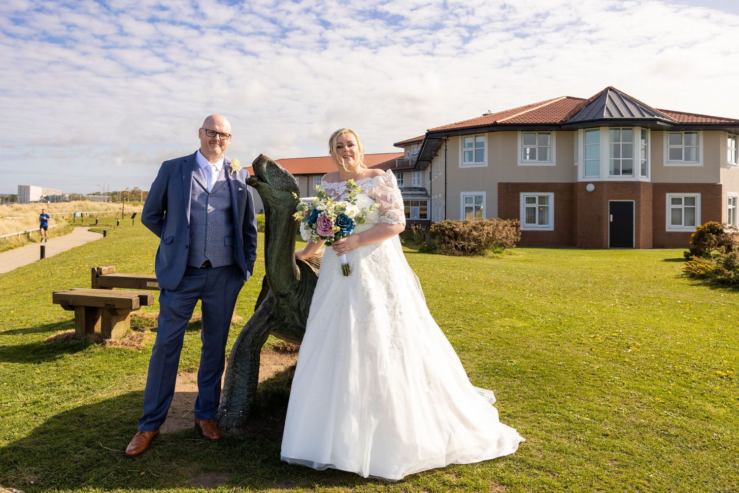 Bride and groom pose by the coast in South Shields, a relaxed seaside wedding portrait capturing love, light and beautiful North East views.